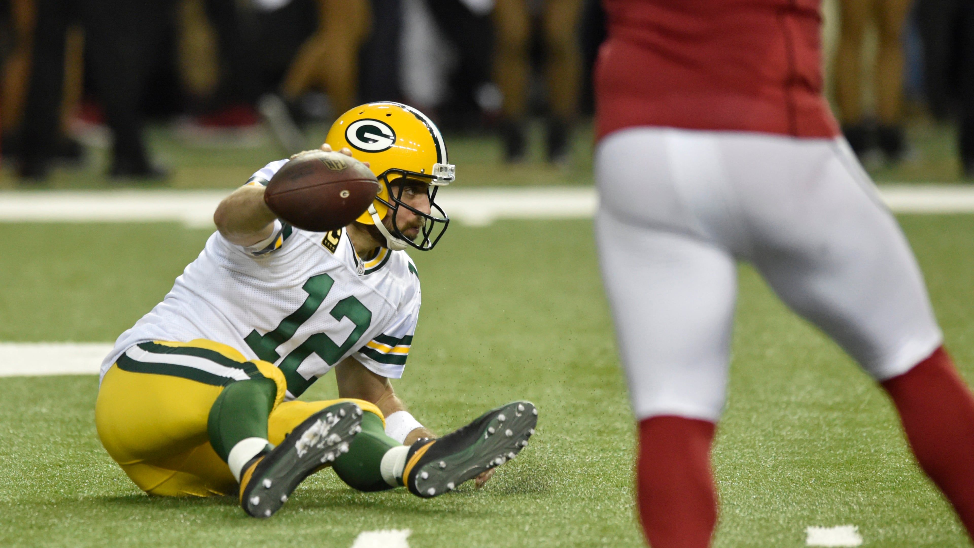January 22, 2017, Atlanta - Packers quarterback Aaron Rodgers (12) falls backwards during the NFC Championship game against the Packers in Atlanta, Georgia, on Sunday, January 22, 2017. (DAVID BARNES / DAVID.BARNES@AJC.COM)