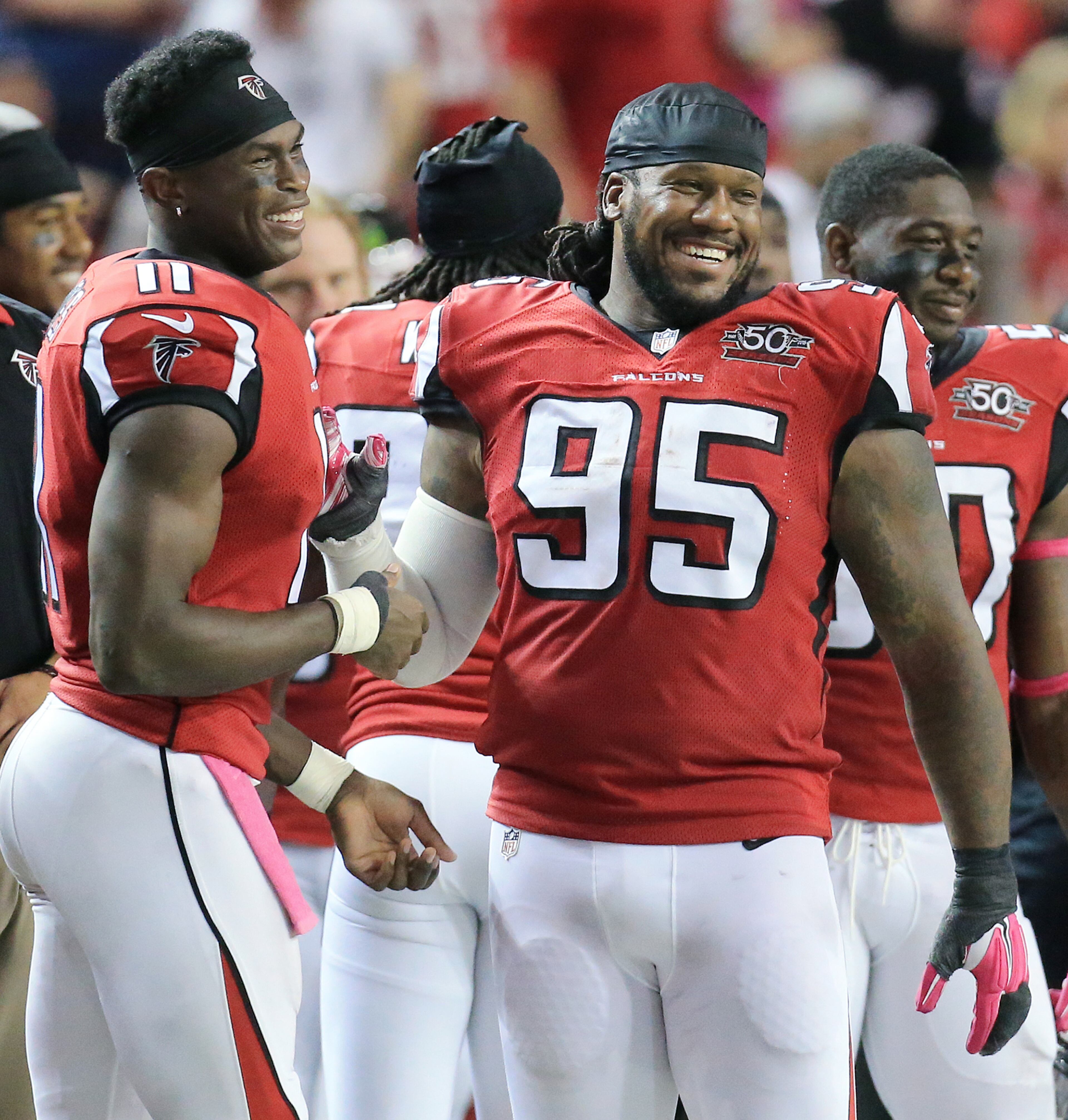Falcons Julio Jones and Jonathan Babineaux share a laugh on the sidelines as the Falcons take a 42-0 lead over the Texans in a football game on Sunday, Oct. 4, 2015, in Atlanta. The Falcons beat the Texans 48-21.