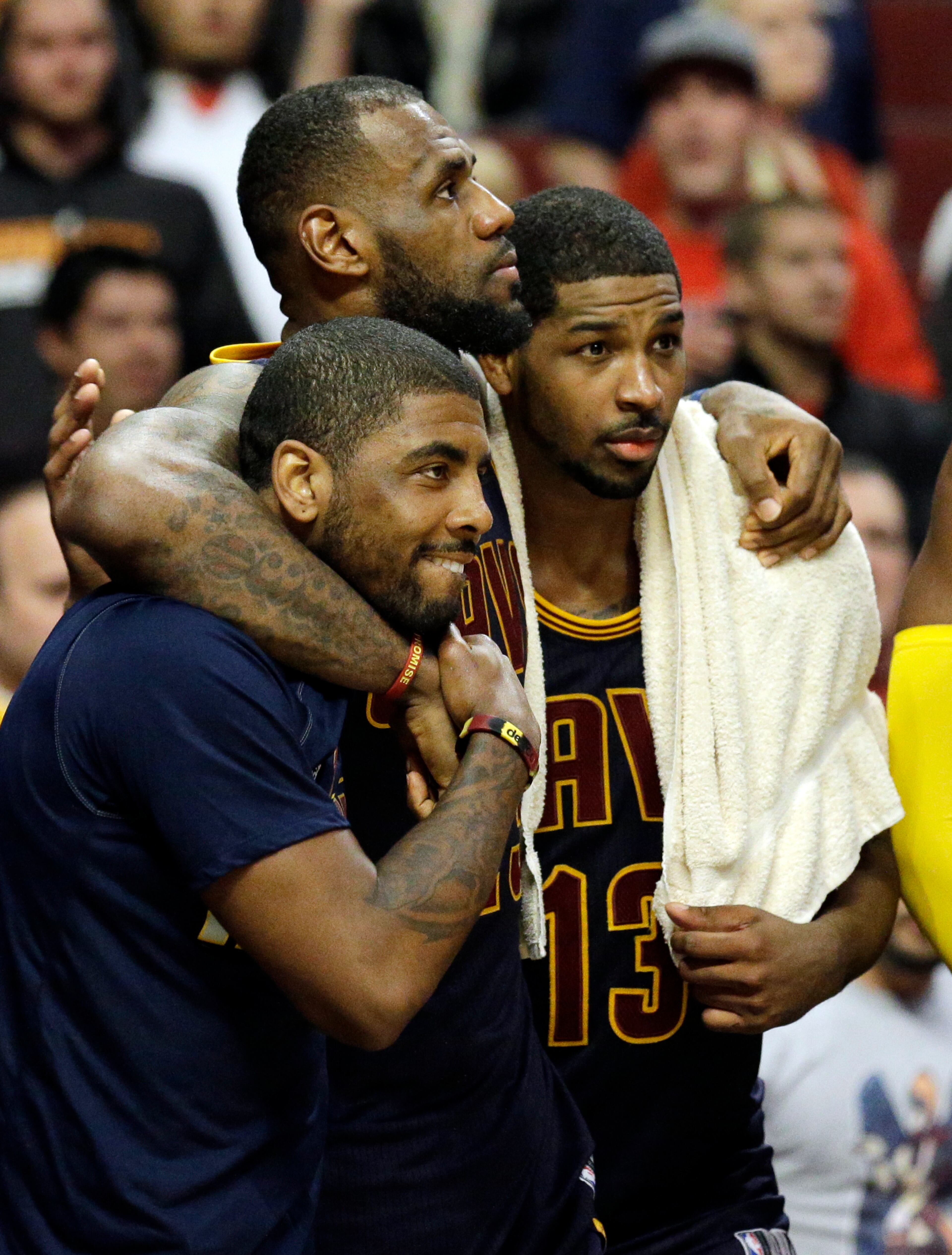 Cleveland Cavaliers forward LeBron James, center, watches the end of the game against the Chicago Bulls with guard Kyrie Irving, left, and center Tristan Thompson during the second half of Game 6 in a second-round NBA basketball playoff series in Chicago on Thursday, May 14, 2015. The Cavaliers won 94-73. (AP Photo/Nam Y. Huh)