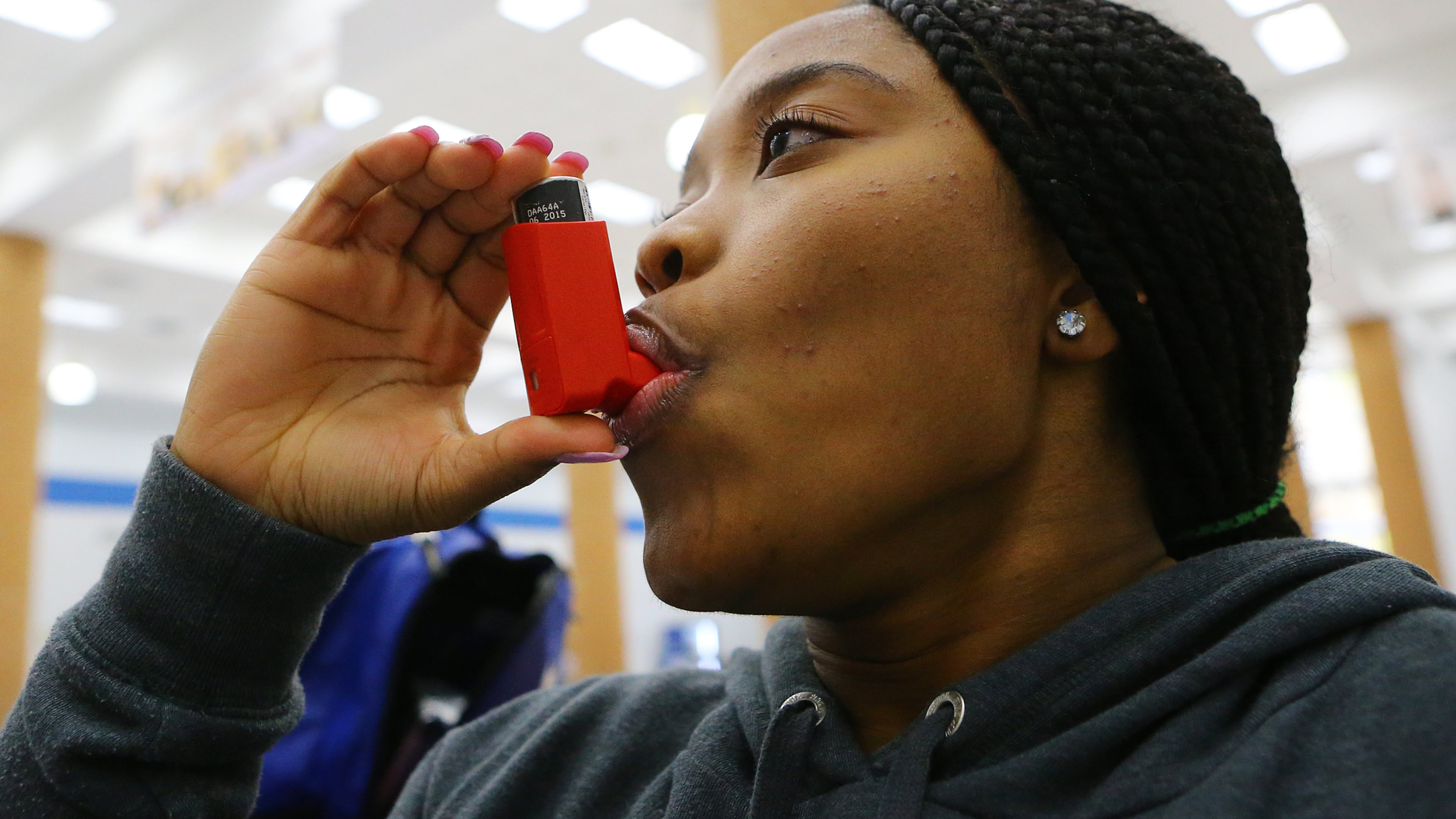 *****POSSIBLE VISUAL LEDE****121514 ATLANTA: NNaserri Carew-Johnson uses an inhaler before participating in an after school Zumba exercise class at Westlake High School on Monday, Dec. 15, 2014, in Atlanta. She keeps 2 inhalers ready in case she has an asthma attack, and sometimes uses them as a preventative. CURTIS COMPTON / CCOMPTON@AJC.COM