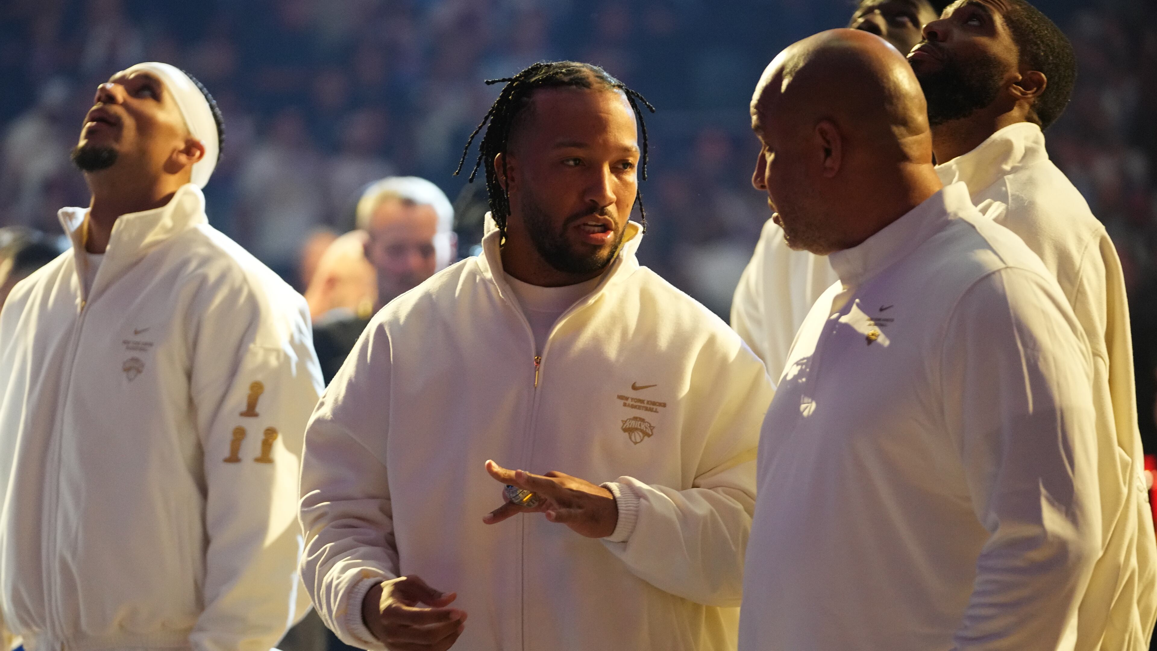 New York Knicks guard Jalen Brunson, center, shows his ring to his father Rick Brunson before an NBA basketball game between the New York Knicks and the Philadelphia 76ers Tuesday, Oct. 20, 2026, in New York. (AP Photo/Frank Franklin II)