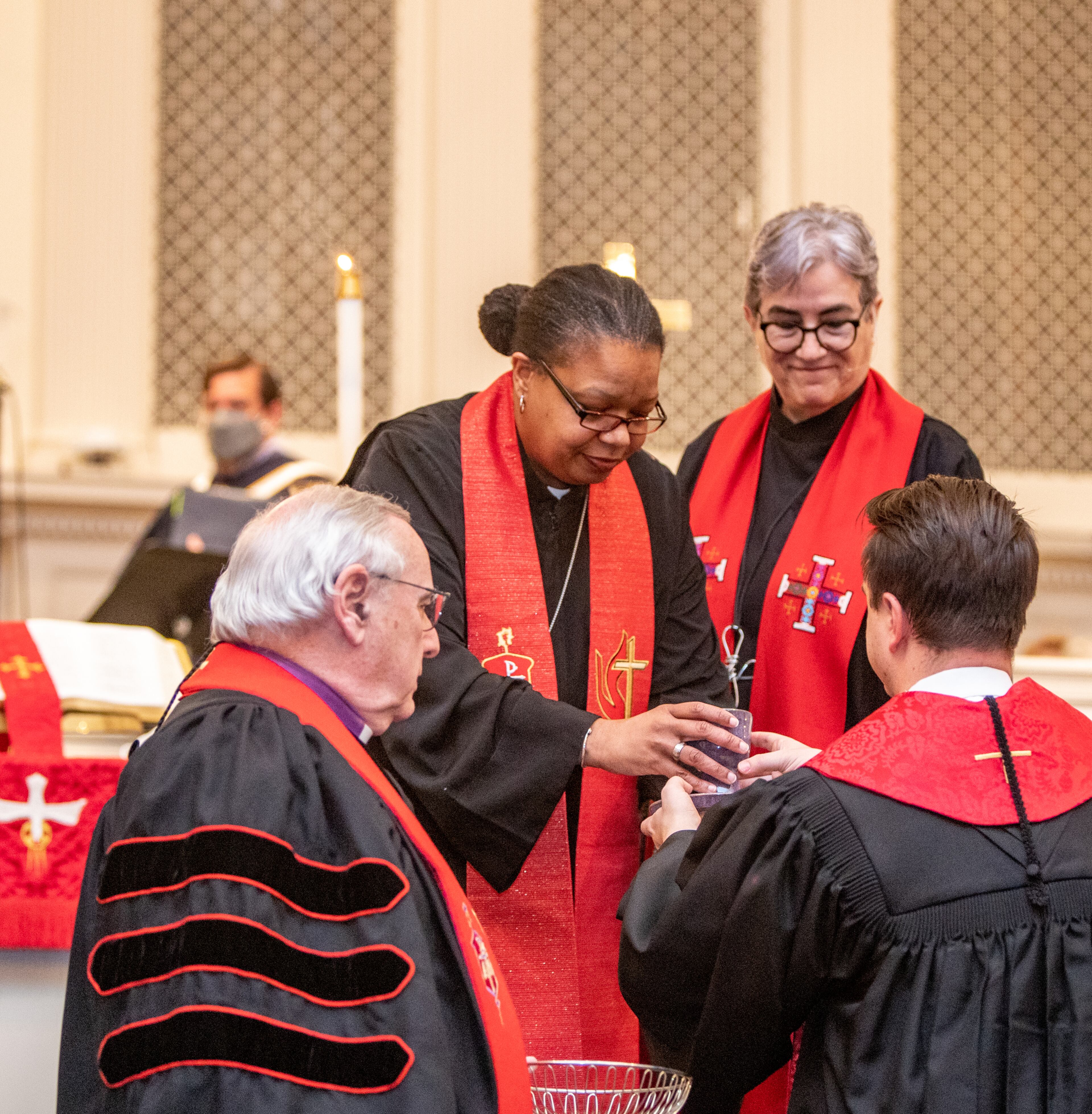 Bishop Robin Dease, right, distributes wine for communion during her installation as leader of the North Georgia Conference United Methodist Church on Sunday, Jan 8, 2023. She is the first African-American female appointed to the position. (Jenni Girtman for the Atlanta Journal-Constitution)