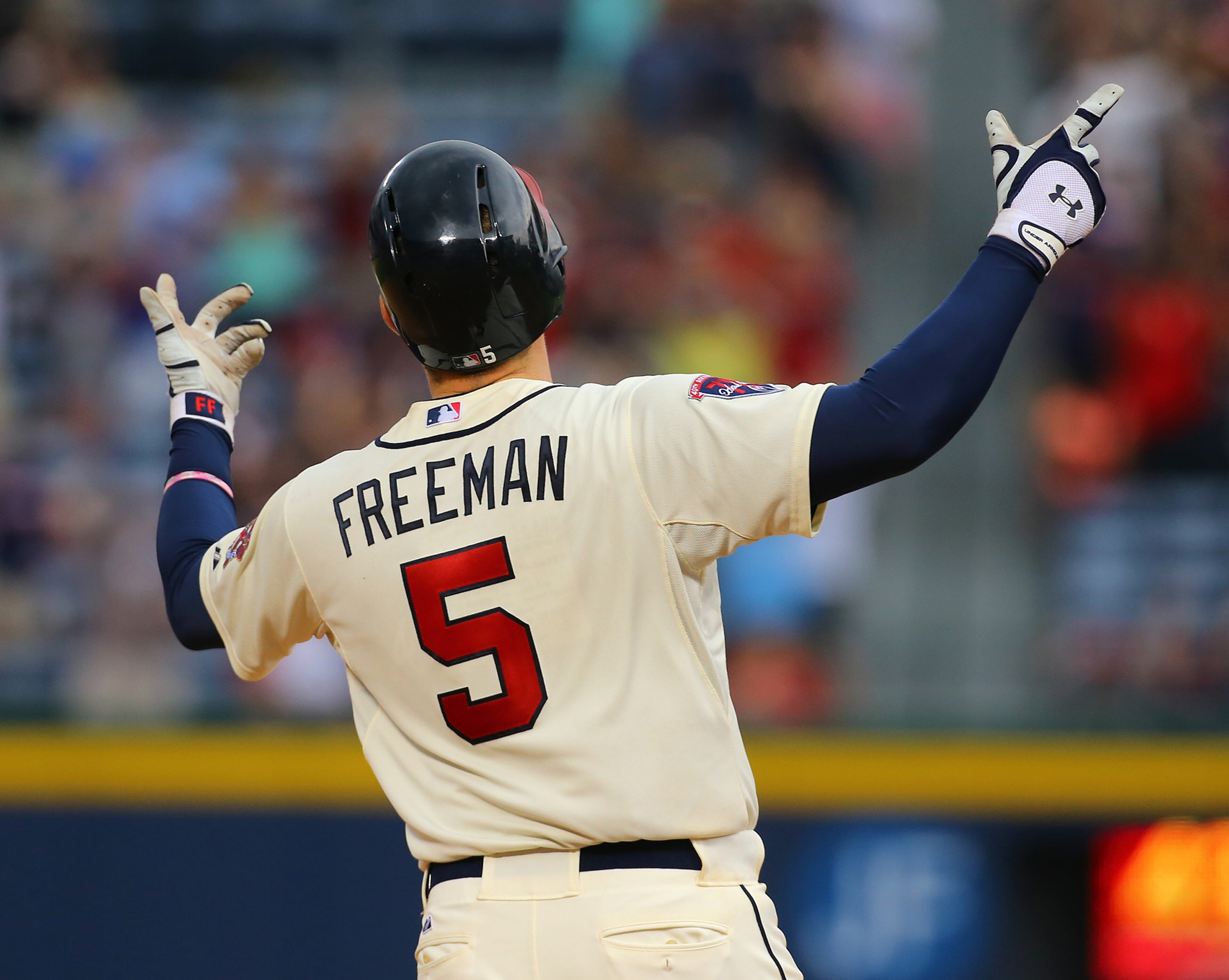 Braves Freddie Freeman begins to celebrate rounding first after hitting a game-winning RBI single to beat the Reds 1-0 for the sweep on Sunday, April 27, 2014, in Atlanta. CURTIS COMPTON / CCOMPTON@AJC.COM