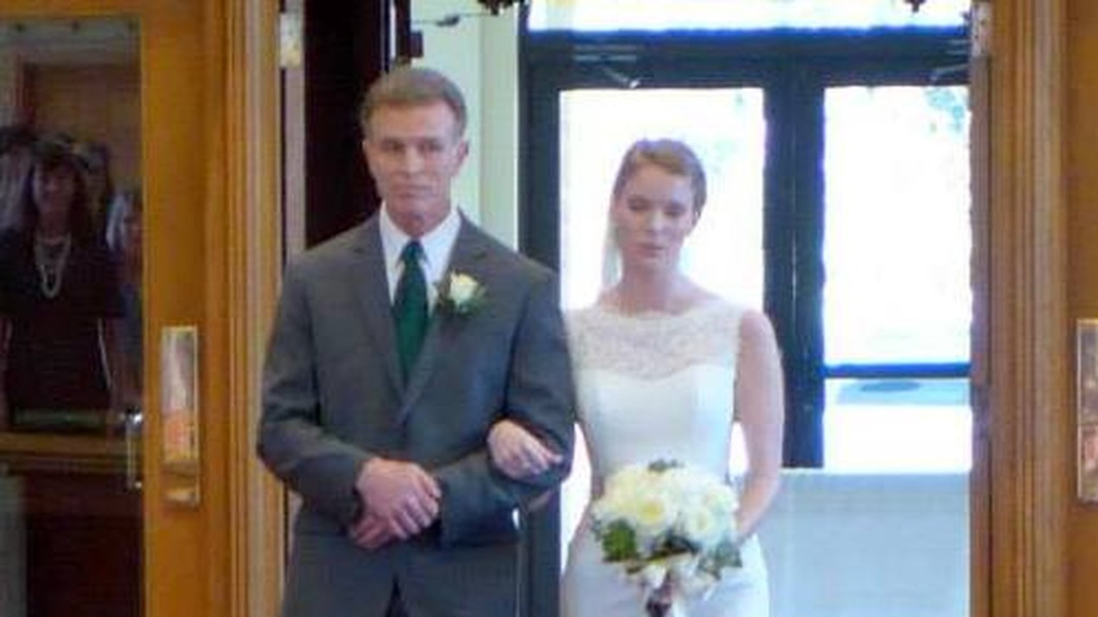 Nearly 20 years after a rocky first day at St. Thomas More school, Emma Torpy and dad take a walk down the aisle in the church upstairs. LINDA DARRAH