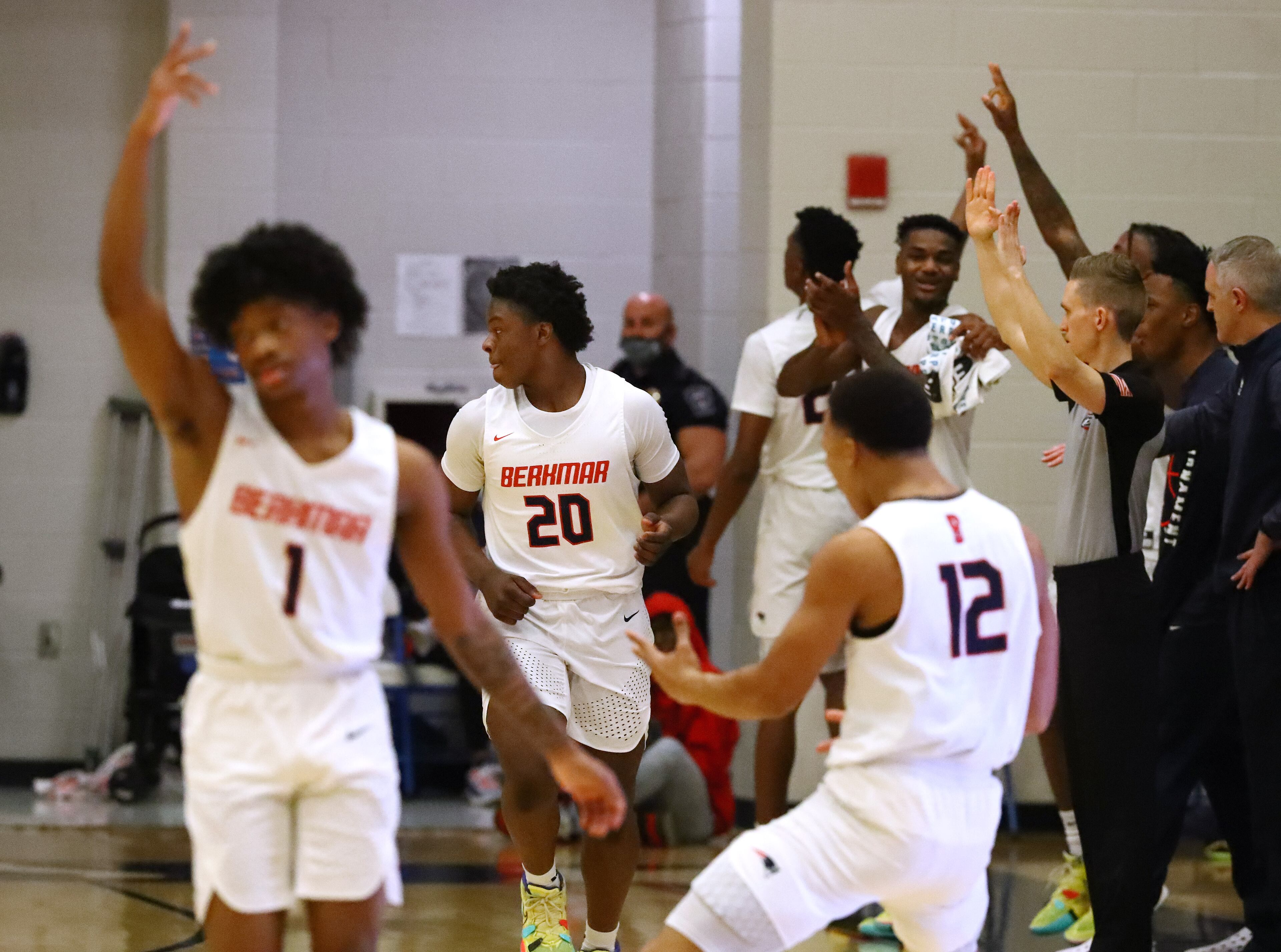 022222 Berkmar: Berkmar teammates react as guard Dante White (center) hits a three pointer against Etowah in a high school basketball tournament on Tuesday, Feb. 22, 2022, in Lilburn. Berkmar advances with a 61-39 victory over Etowah. “Curtis Compton / Curtis.Compton@ajc.com”`