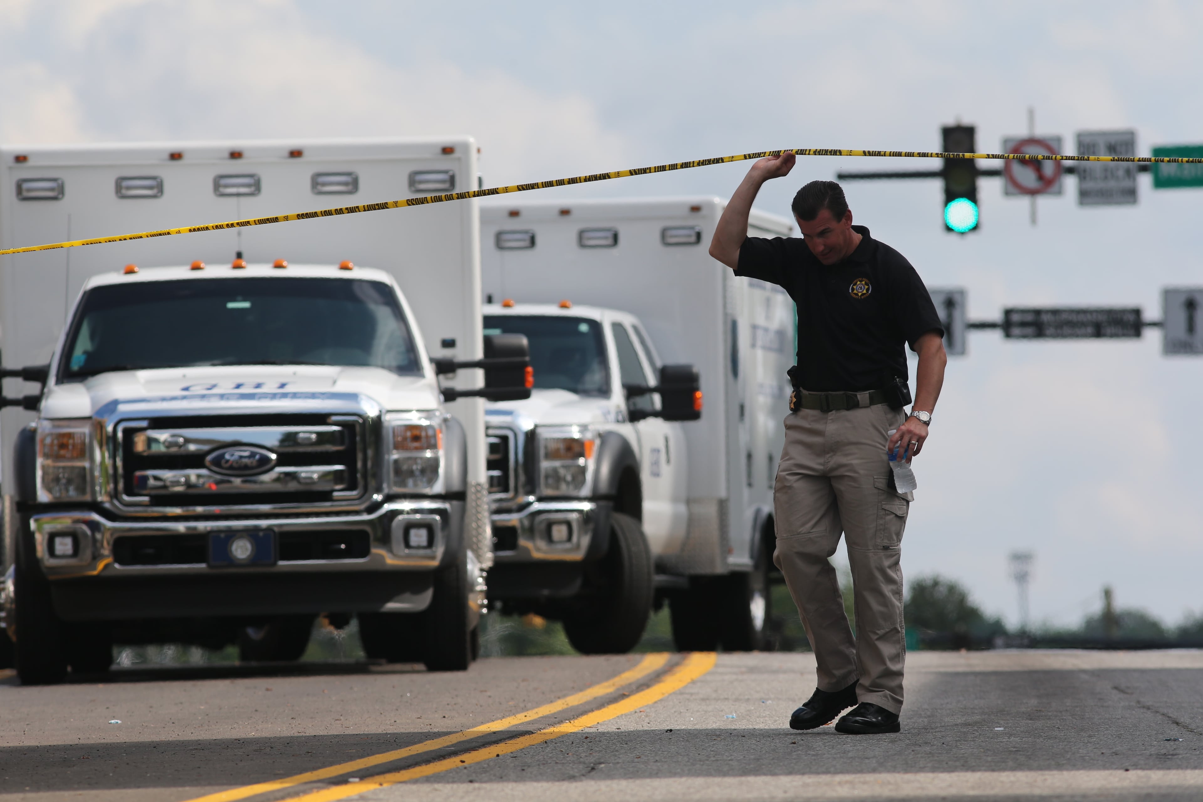 Authorities investigate the scene of shooting that took place in front of the Forsyth County courthouse in Cumming, Ga., on June 6, 2014.
