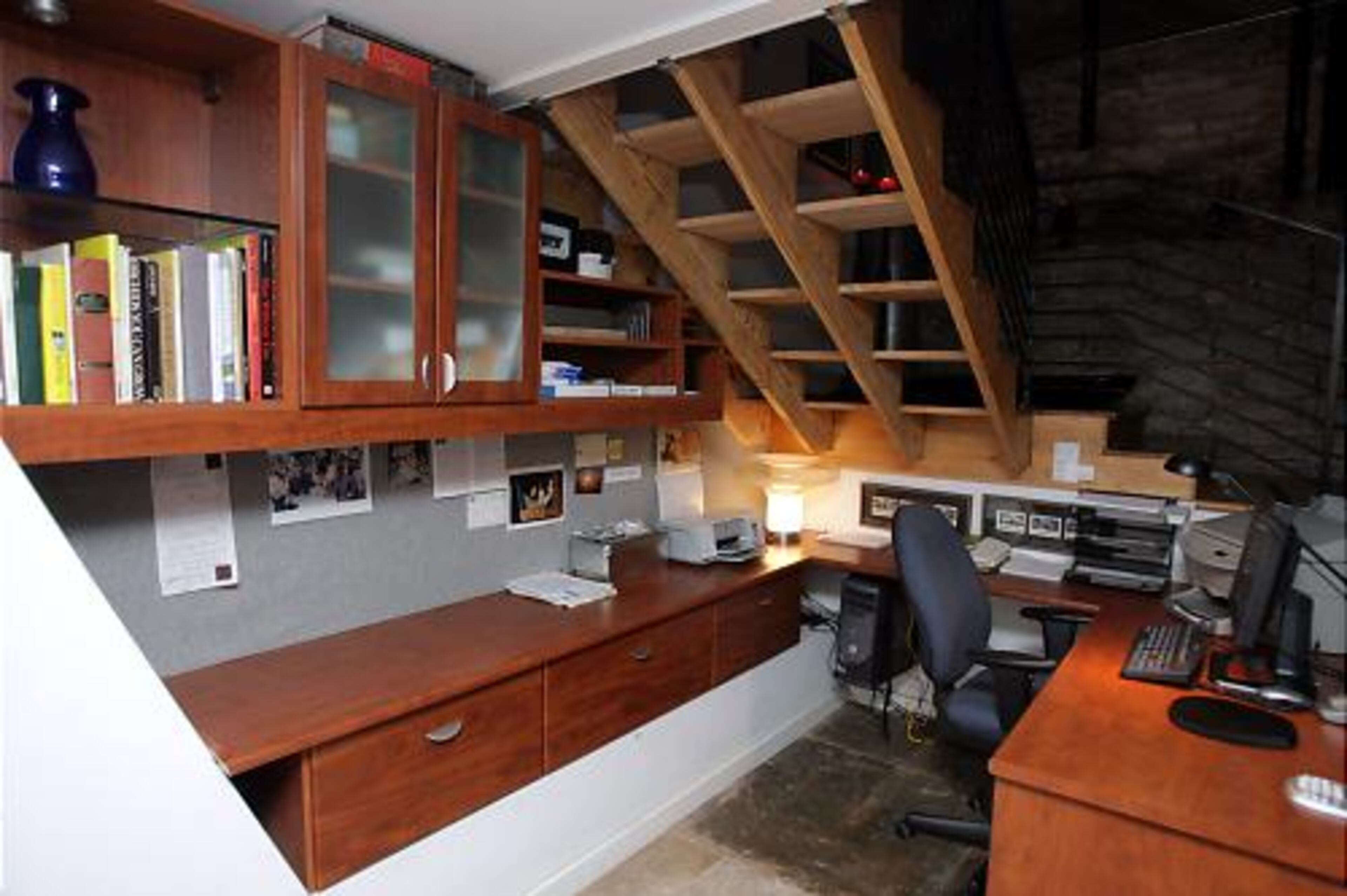The space under the lower level stairs is put to good use as an office.