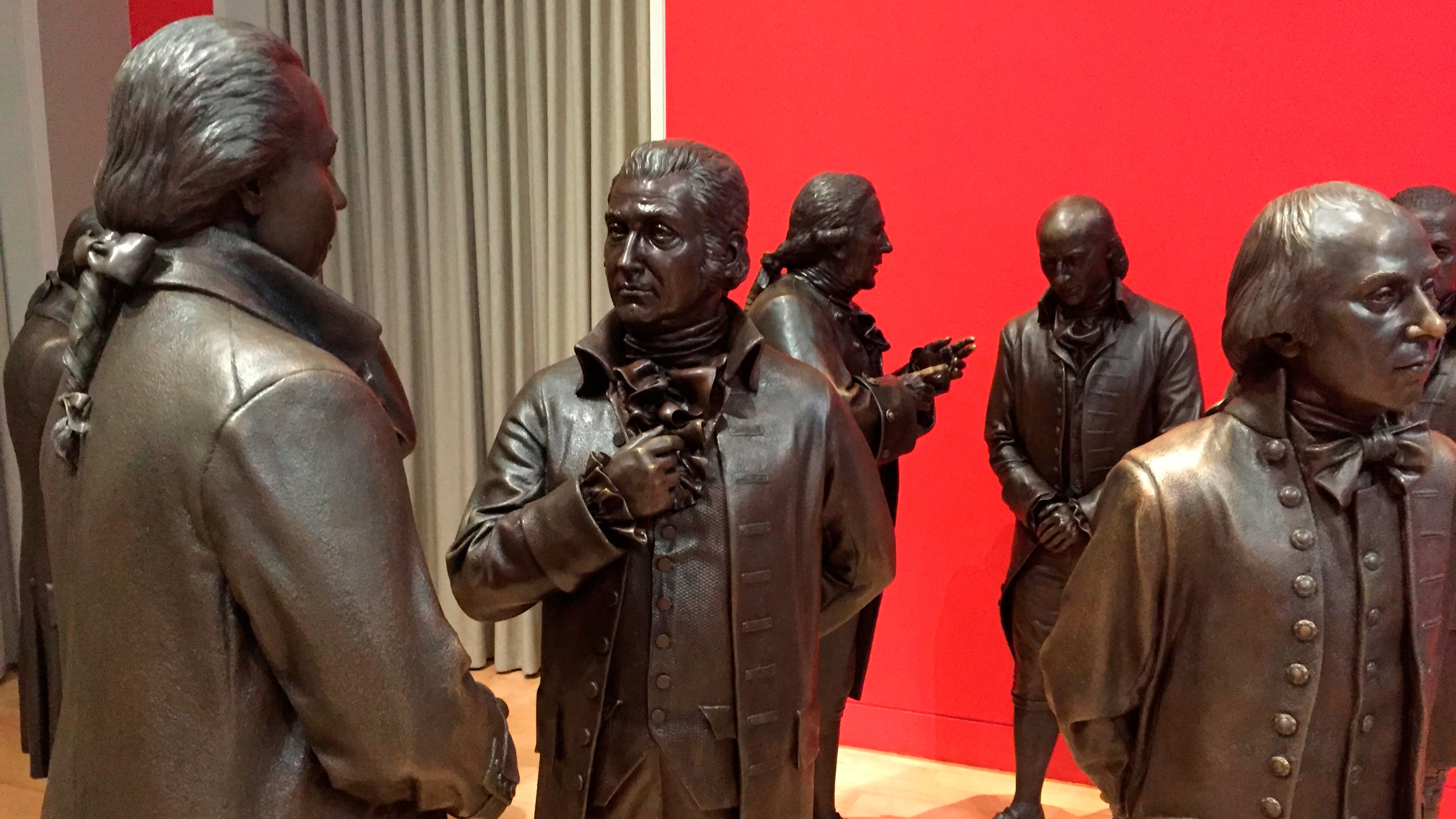 FILE - Life-size bronze sculptures of the signers of the U.S. Constitution stand in the Signers' Hall on July 7, 2016, at the National Constitution Center in Philadelphia. (AP Photo/Beth J. Harpaz, File)