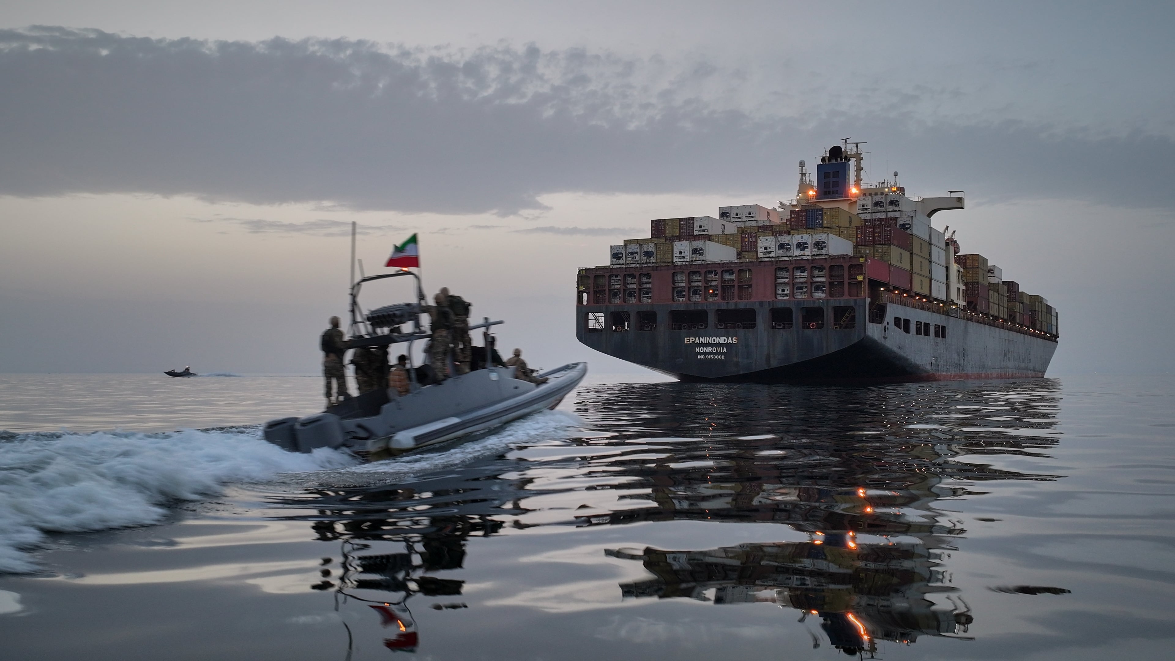 FILE - In this photo released by Tasnim News Agency, a Revolutionary Guard Navy (IRGC) speedboat approaches the cargo ship Epaminondas during what state media described as the seizure of one of two vessels accused of violations in the Strait of Hormuz, April 21, 2026. (Meysam Mirzadeh/Tasnim News Agency via AP, File)