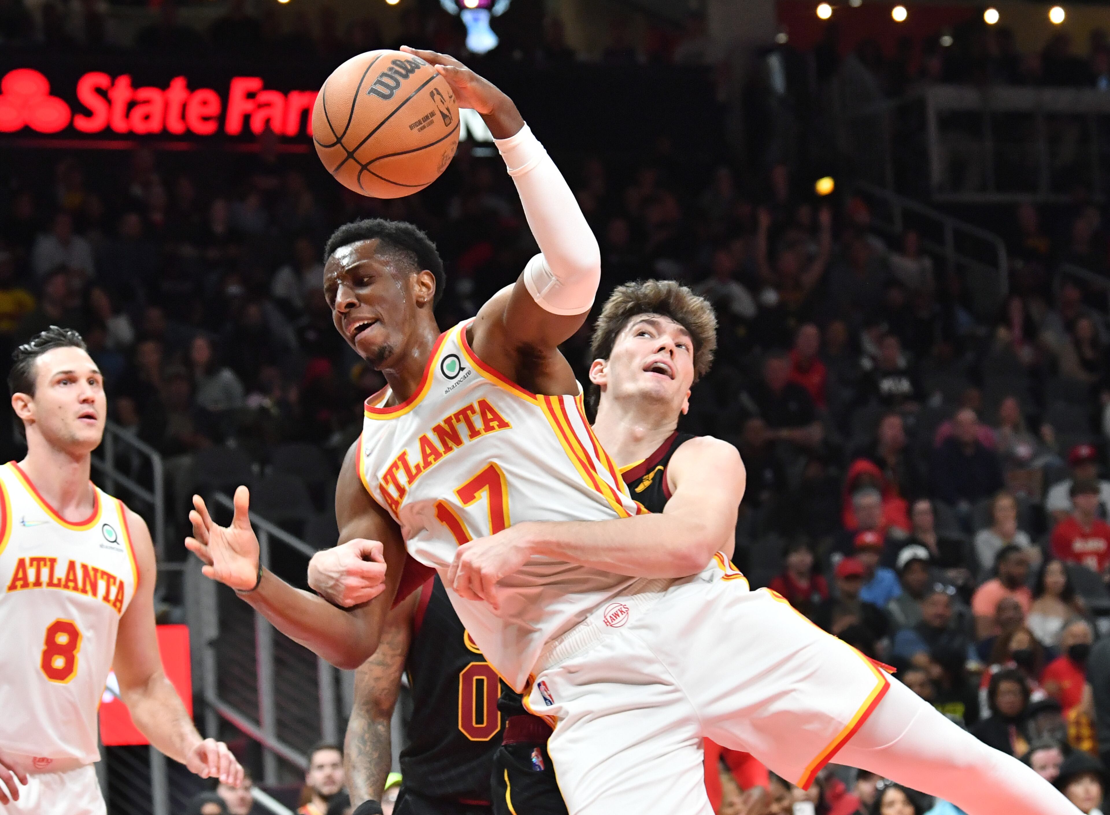 Hawks' forward Onyeka Okongwu (17) is fouled by Cleveland Cavaliers' forward Cedi Osman (16) during the first half in an NBA basketball game at State Farm Arena on Thursday, March 31, 2022. Atlanta Hawks won 131-107 over Cleveland Cavaliers. (Hyosub Shin / Hyosub.Shin@ajc.com)
