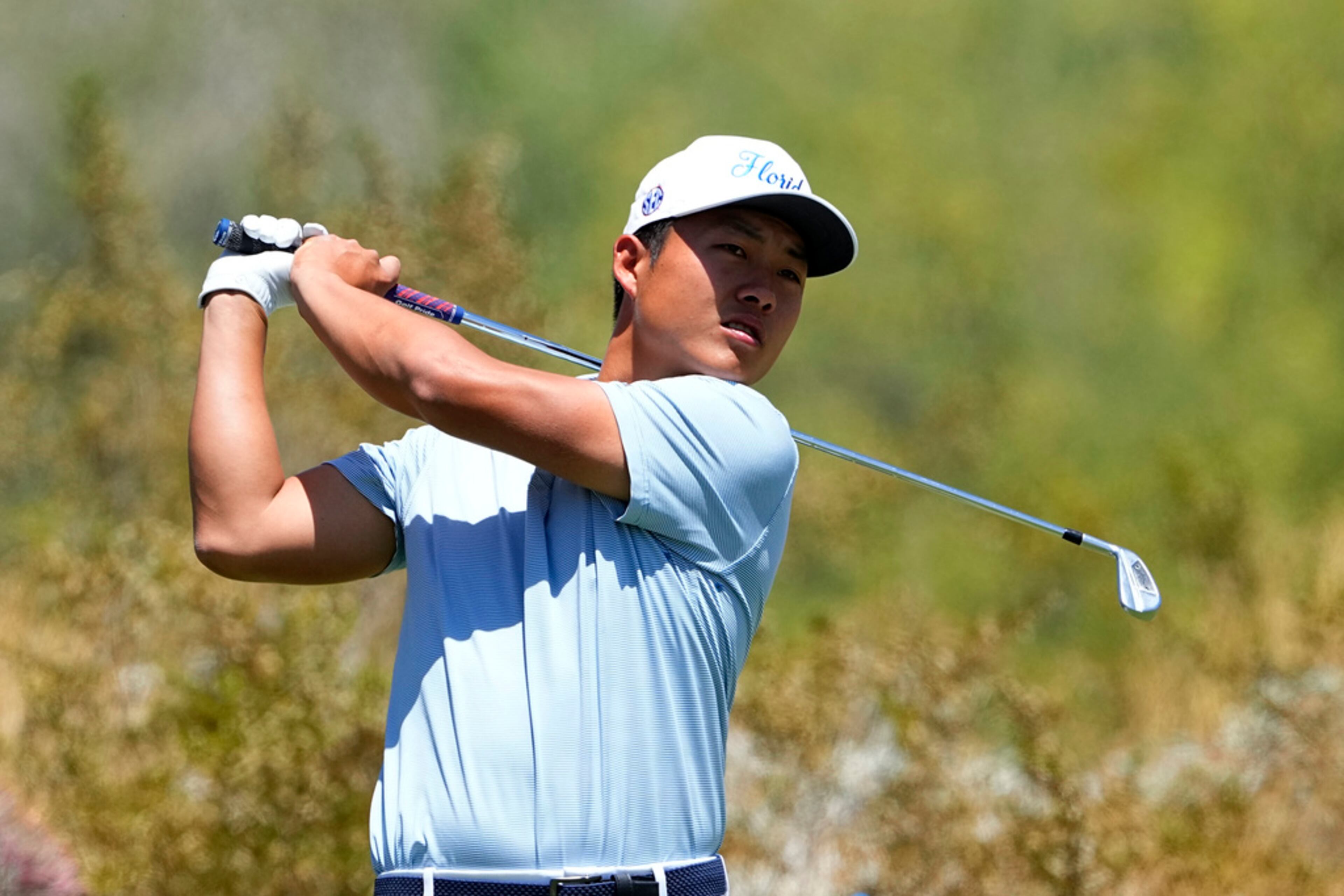 Florida golfer Yuxin Lin hits from the first tee during the final round of the NCAA college men's match play golf championship, Wednesday, May 31, 2023, in Scottsdale, Ariz. (AP Photo/Matt York)