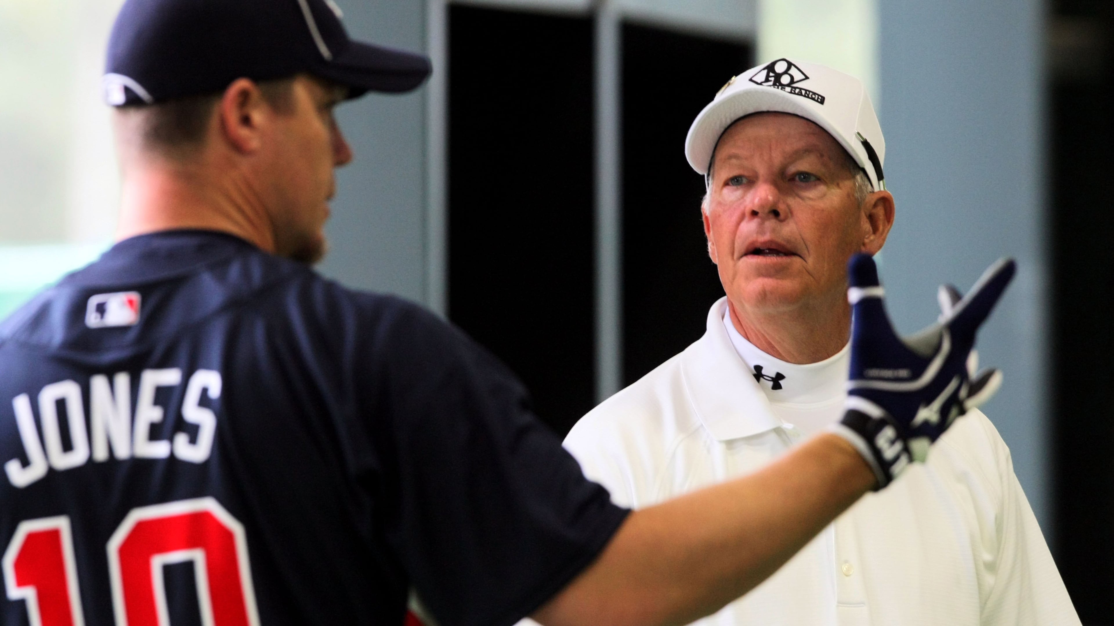 Chipper Jones (left) chats with his father, Larry Jones, during batting practice at the Braves' spring training facility
