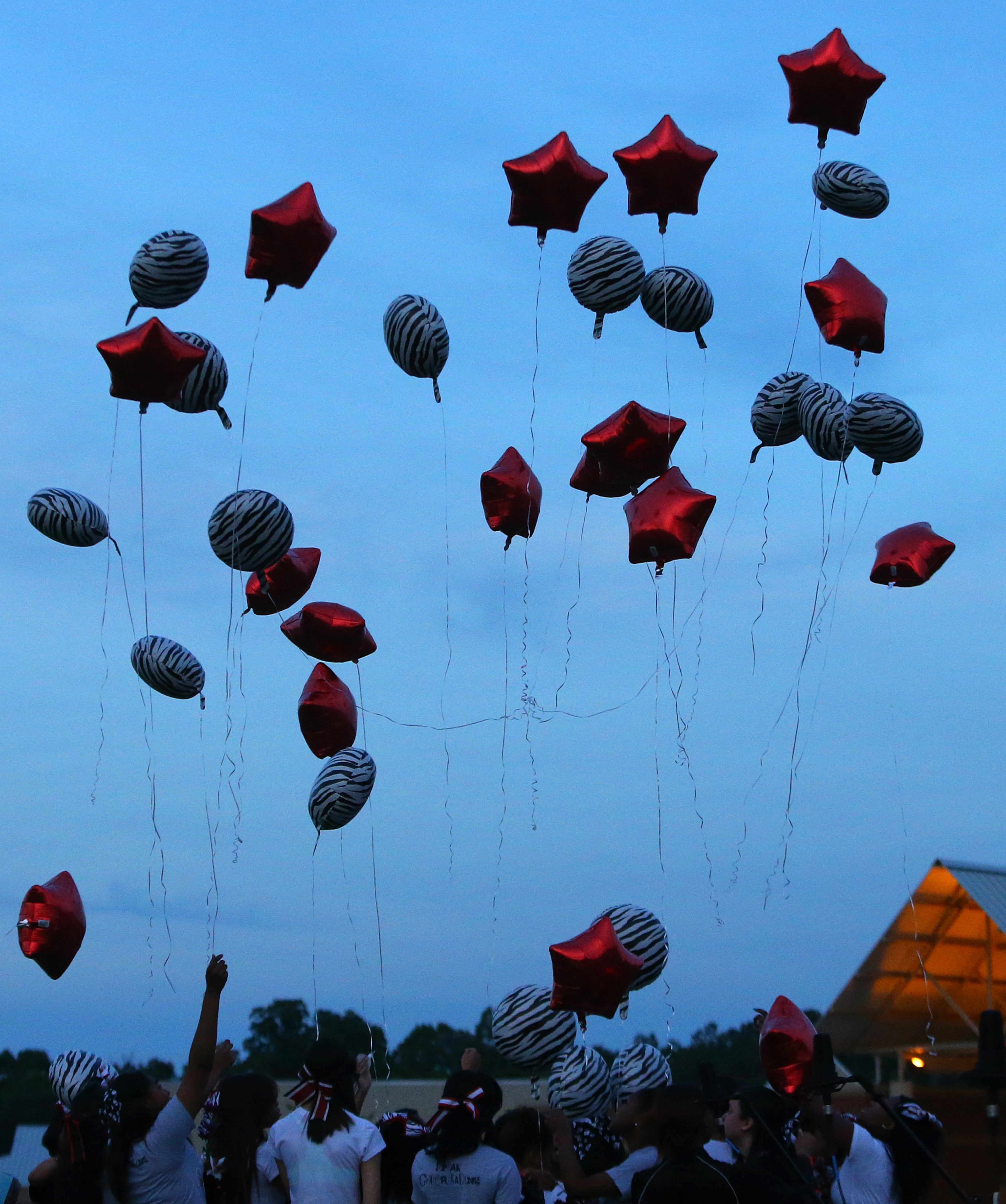 Cheerleaders release balloons during a candlelight vigil to remember fellow cheerleader16-year-old Henry County girl Jasmine Poole in the football stadium at Dutchtown High School on Thursday, May 8, 2014, in Hampton. Poole was killed and two other teens injured in a Wednesday afternoon wreck. CURTIS COMPTON / CCOMPTON@AJC.COM
