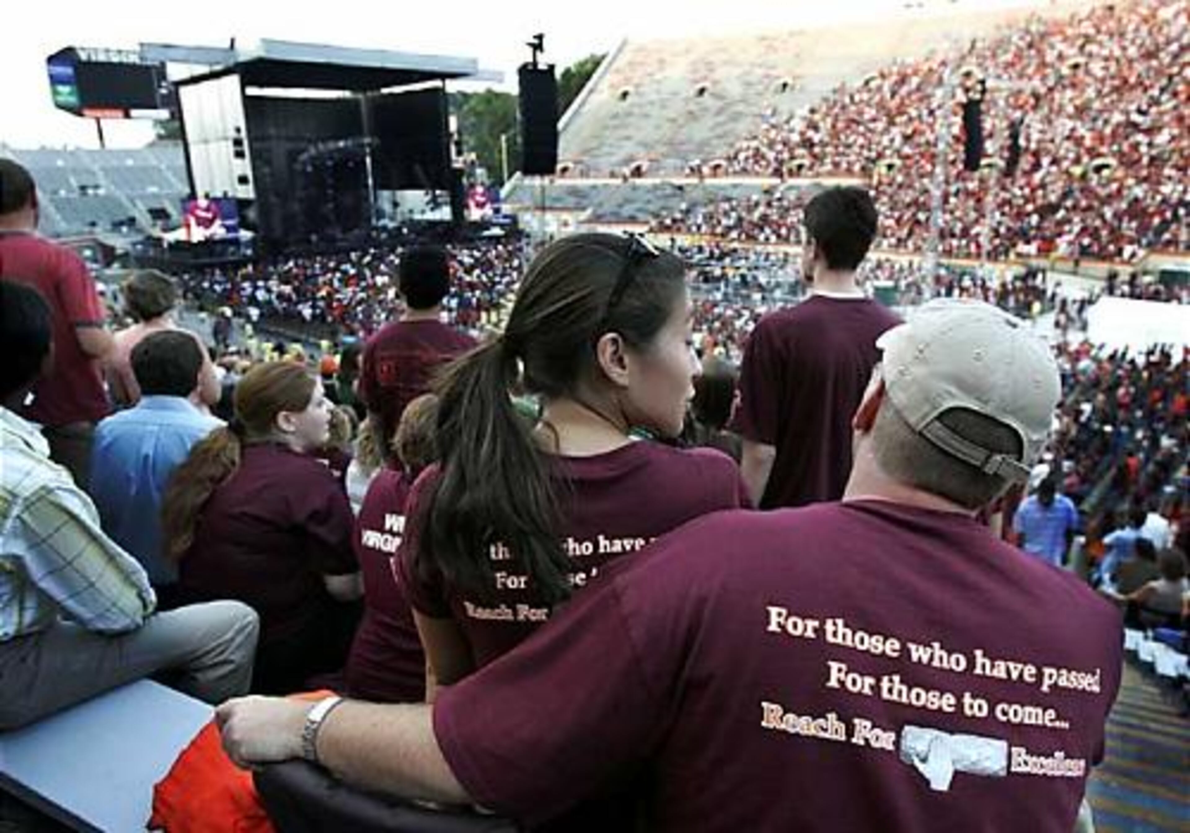 Fans seated in Lane stadium watch the performance of John Mayer.