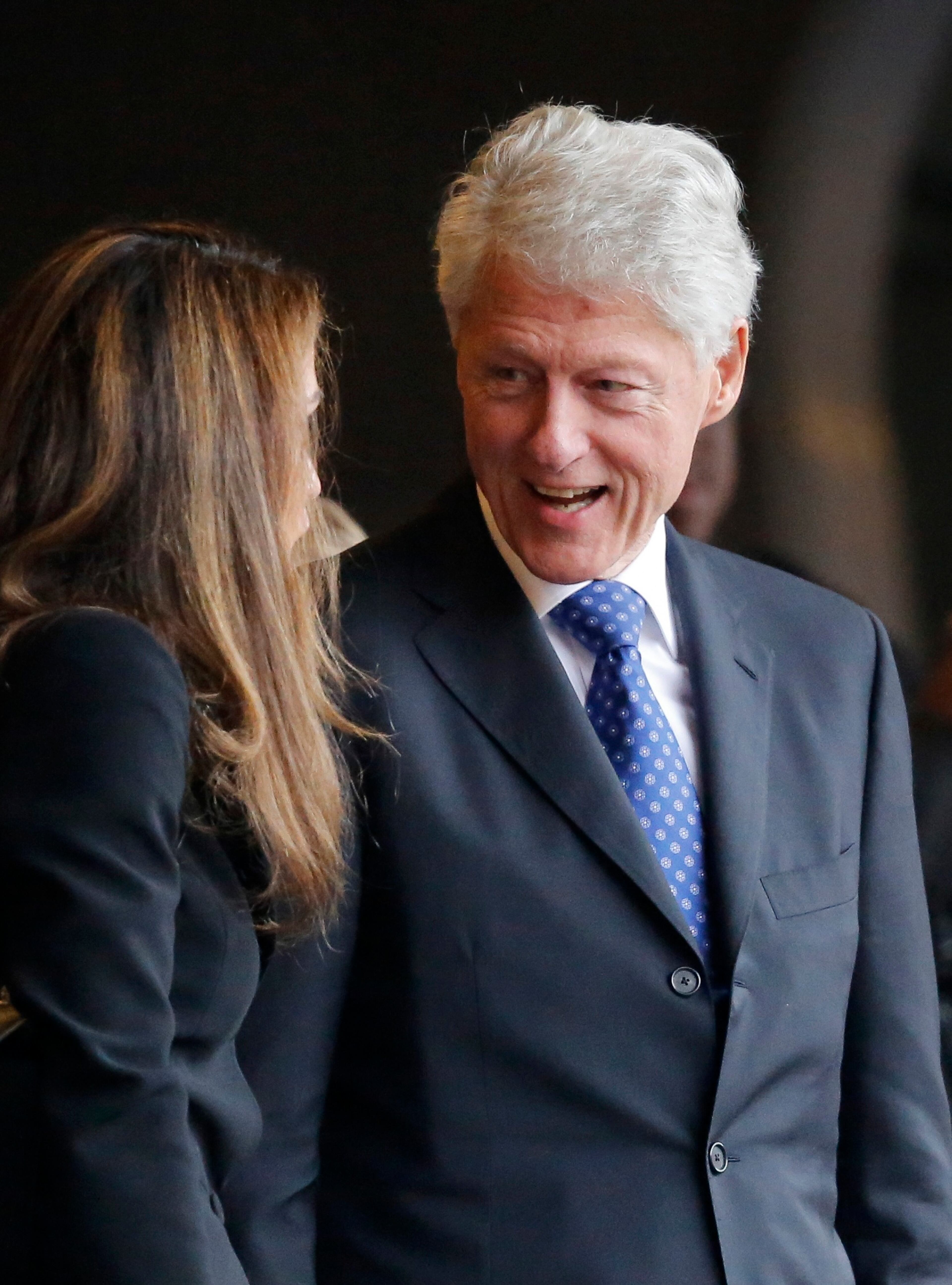Former President Bill Clinton speaks with Jordan's Queen Rania during the memorial service for former South African President Nelson Mandela at the FNB stadium in Johannesburg, South Africa Tuesday, Dec. 10, 2013. (AP Photo/Ben Curtis)