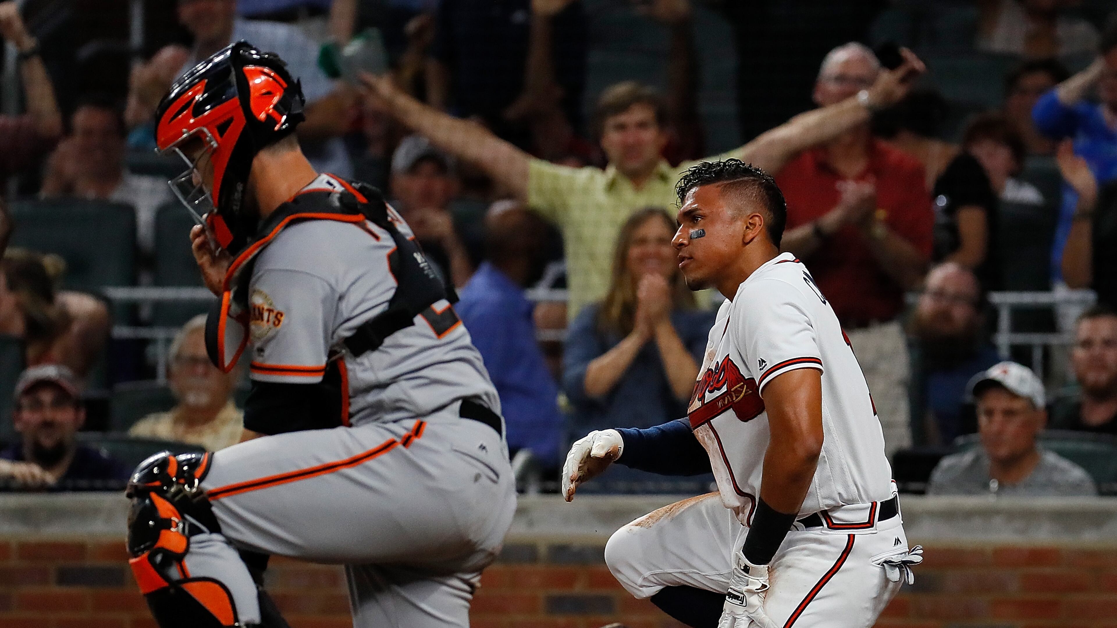 Johan Camargo of the Braves reacts after sliding safely past a mishandled catch by Buster Posey of the San Francisco Giants on a double hit by Ender Inciarte in the third inning at SunTrust Park on June 19, 2017 in Atlanta. (Photo by Kevin C. Cox/Getty Images)