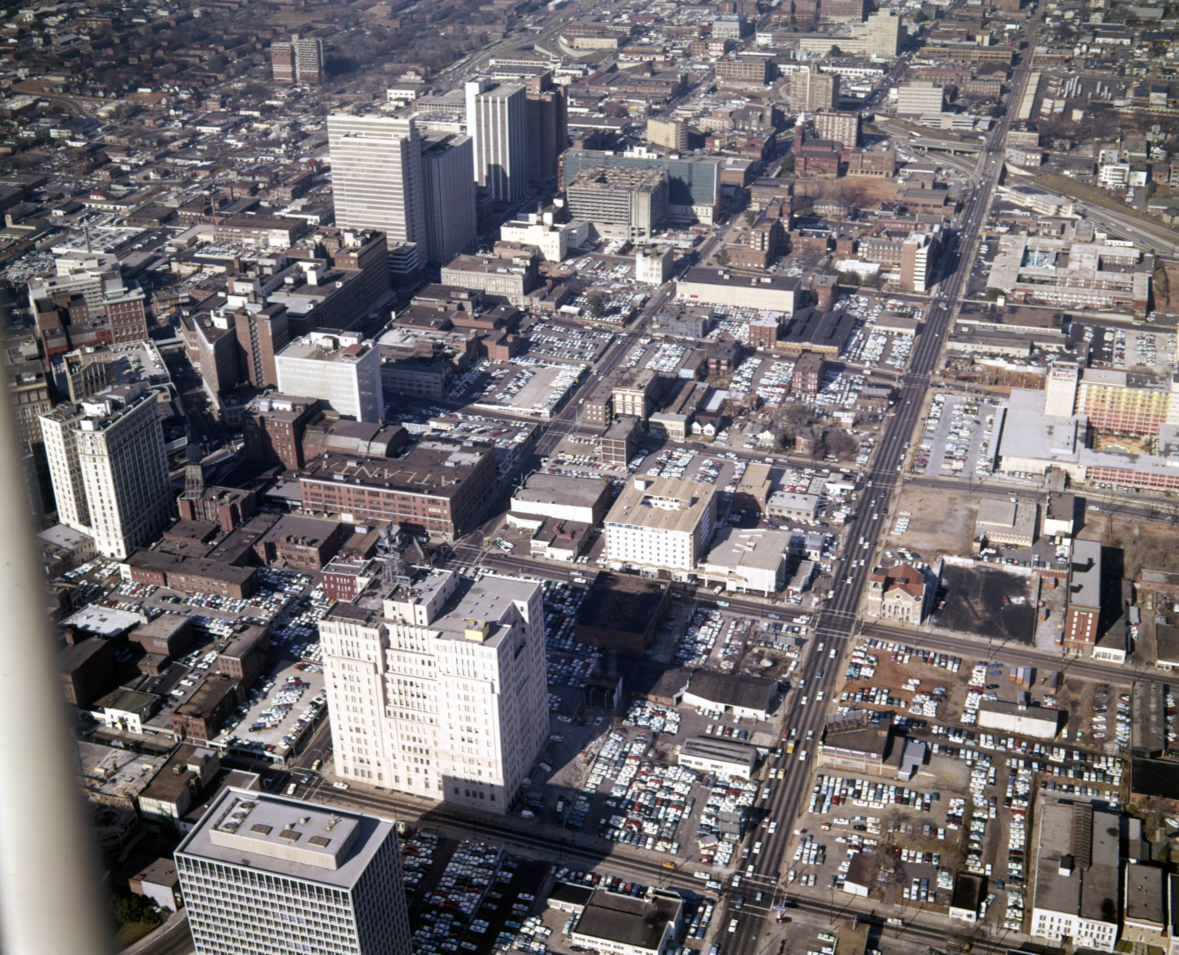 Aerial view of downtown, looking northwest, showing large areas covered in parking lots, Atlanta, Georgia, December 21, 1965. Courtland Street is the prominent road running north on the right-hand side.