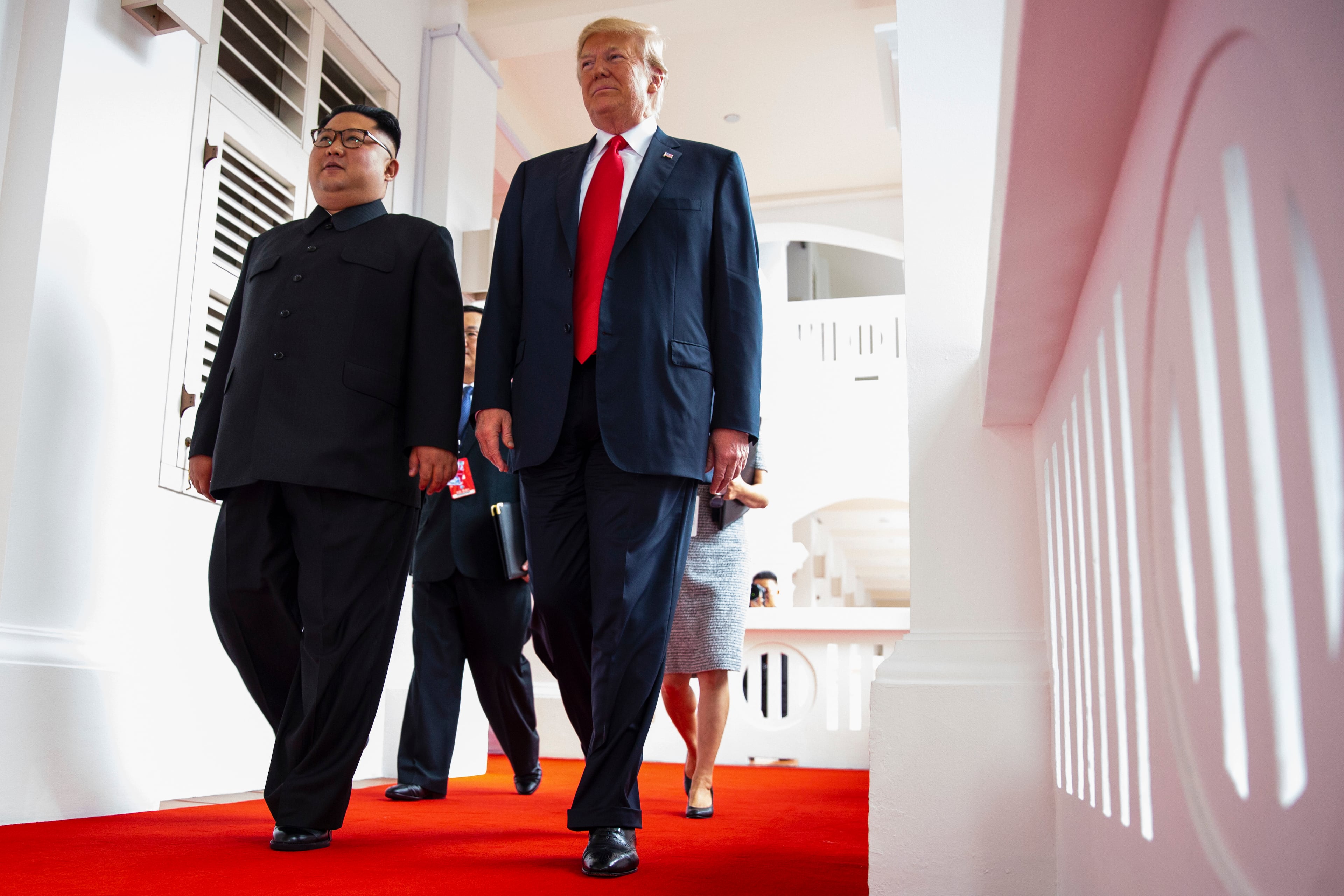 North Korea leader Kim Jong Un and U.S. President Donald Trump walk along the balconies at the Capella resort on Sentosa Island Tuesday, June 12, 2018 in Singapore. (AP Photo/Evan Vucci)