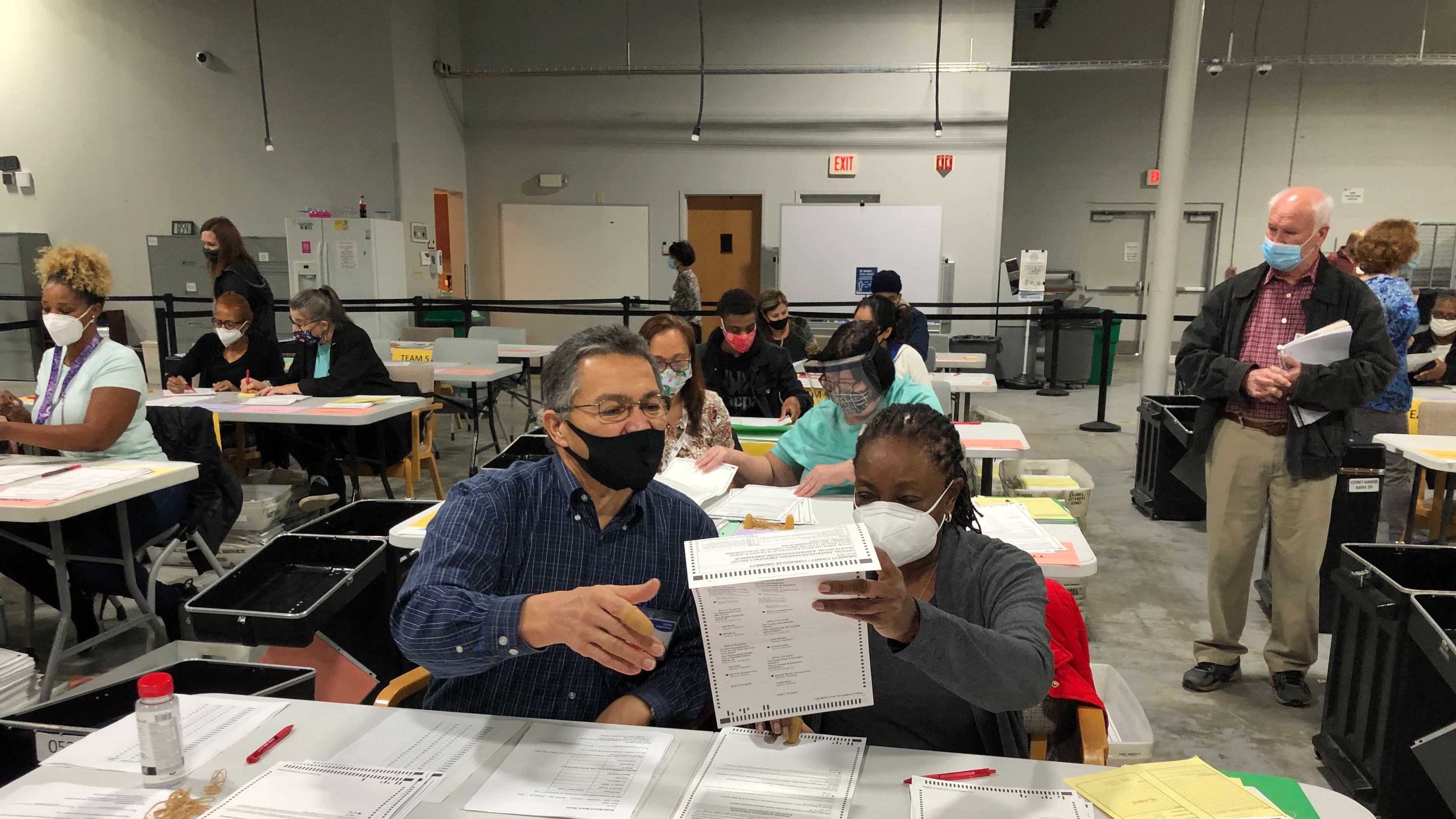 Gwinnett County elections workers count absentee by mail at the county elections building in Lawrenceville.