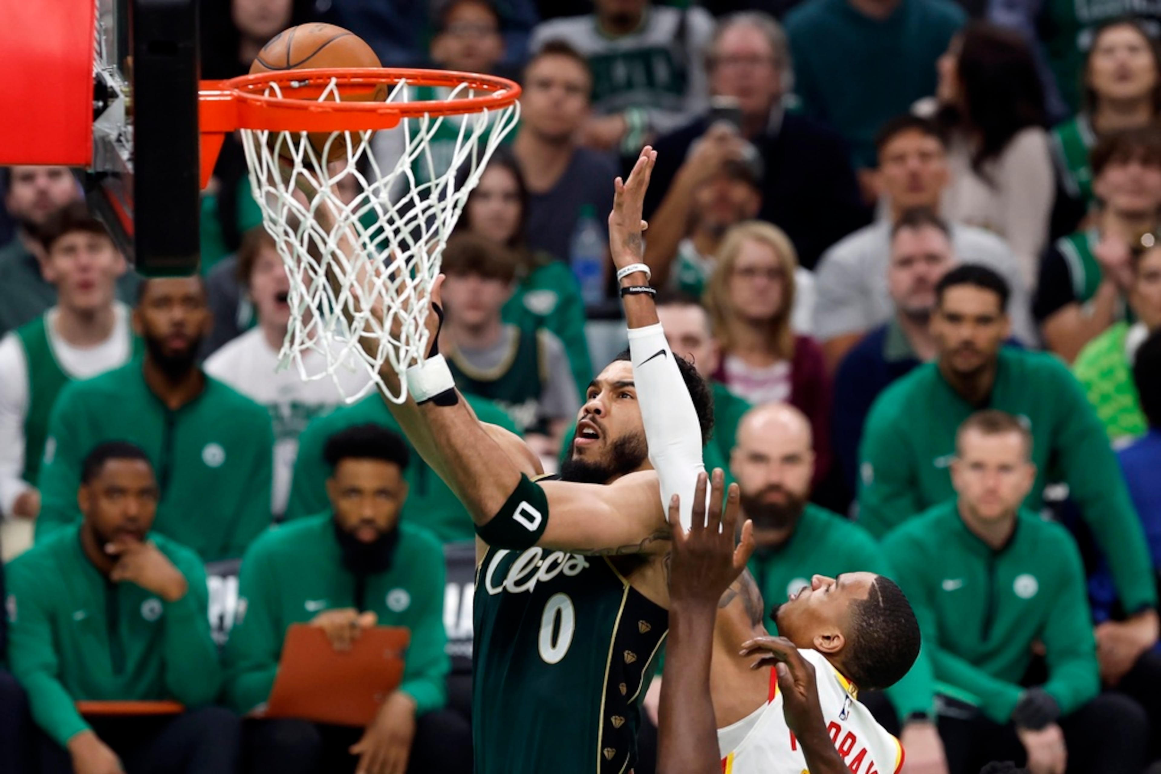 Boston Celtics' Jayson Tatum (0) shoots against Atlanta Hawks' Dejounte Murray in the first half during Game 1 in the first round of the NBA basketball playoffs, Saturday, April 15, 2023, in Boston. (AP Photo/Michael Dwyer)