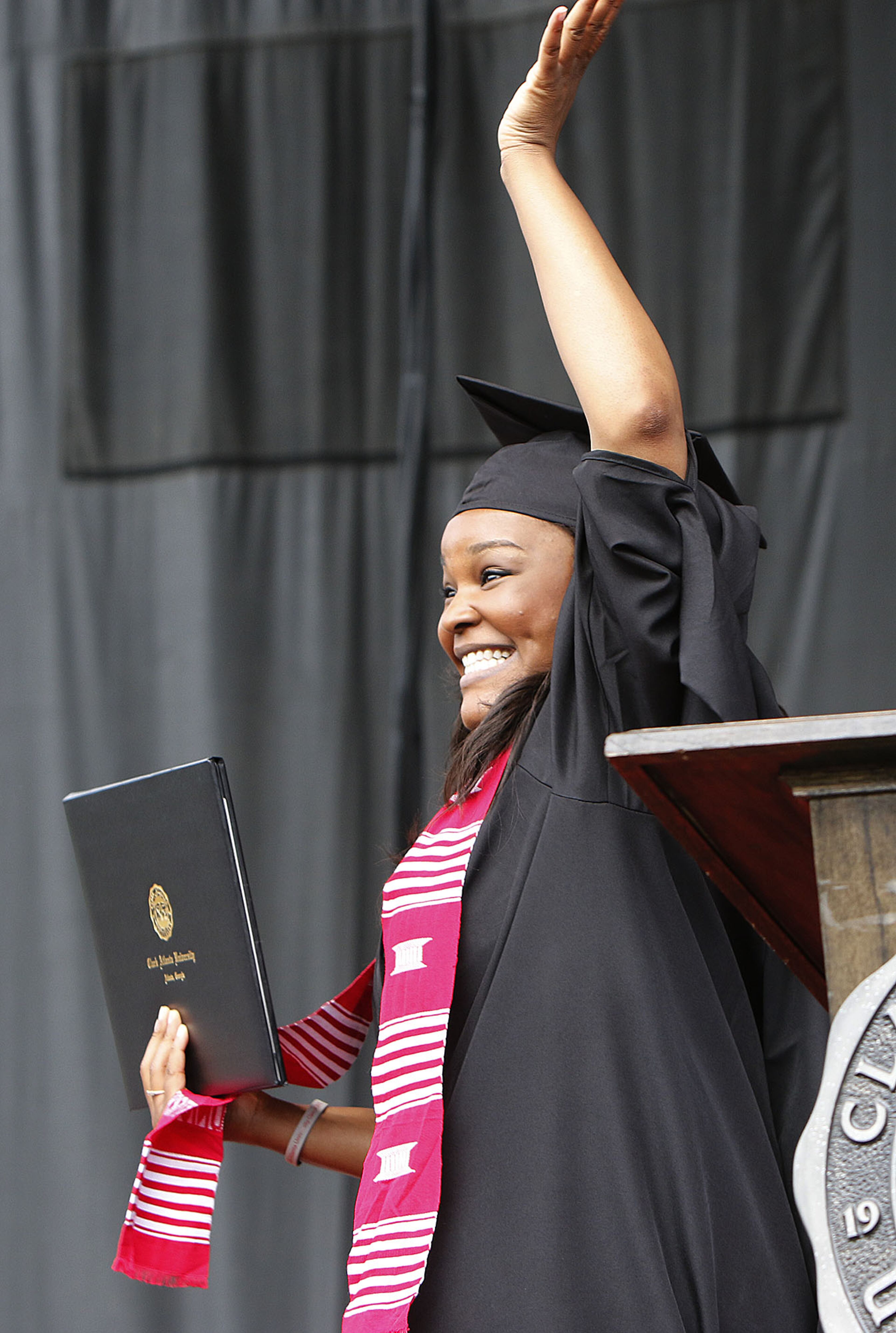 Clark Atlanta University graduate Menisha McCallum waves to family after receiving her degree during ceremonies in Atlanta on Monday May 18, 2015. The keynote speaker is Marc Morial, president and CEO of the National Urban League. (Photo by Phil Skinner)