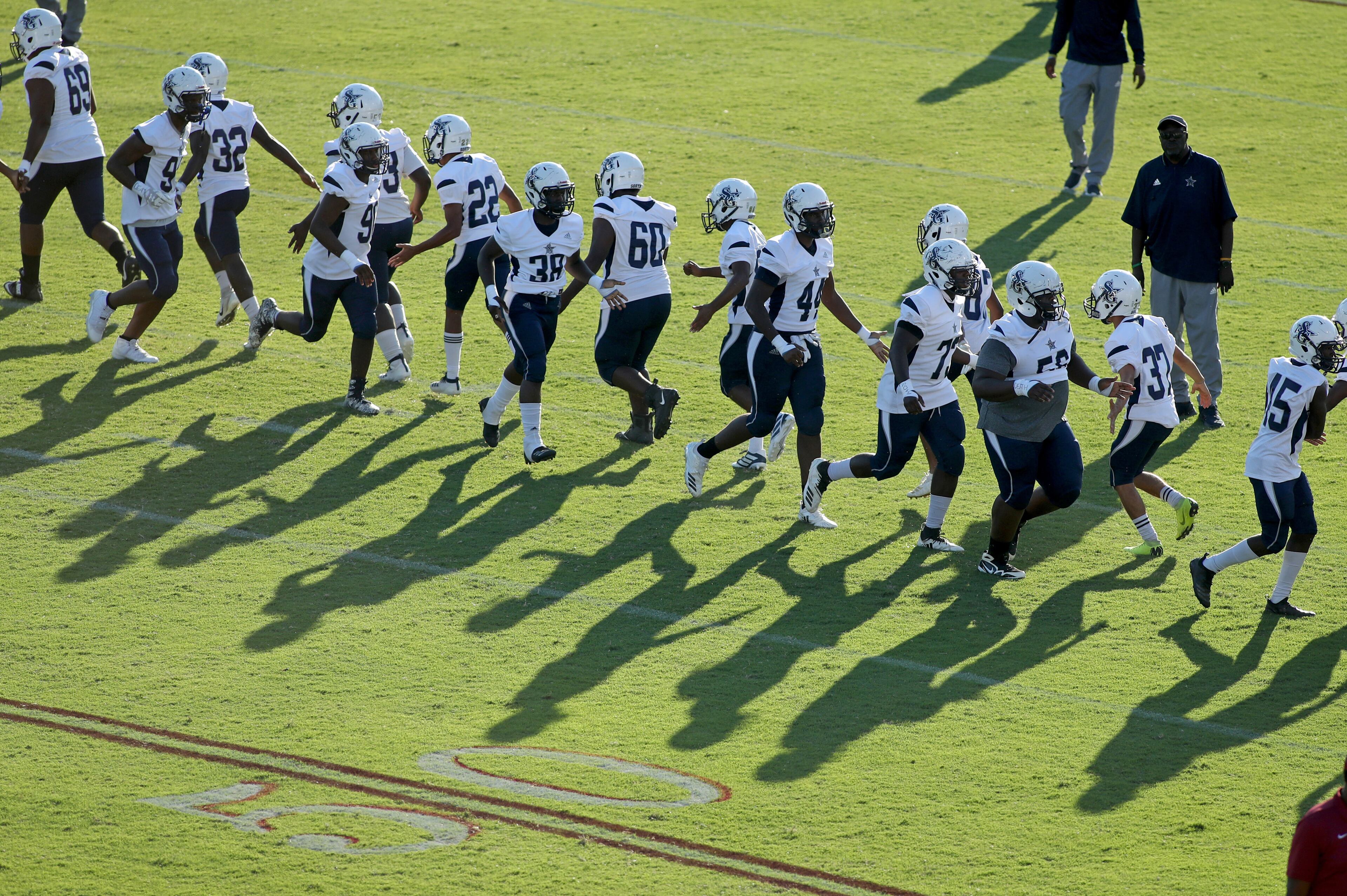 South Gwinnett players warmup before Friday's road game against county rival Brookwood. (Jason Getz/Special)