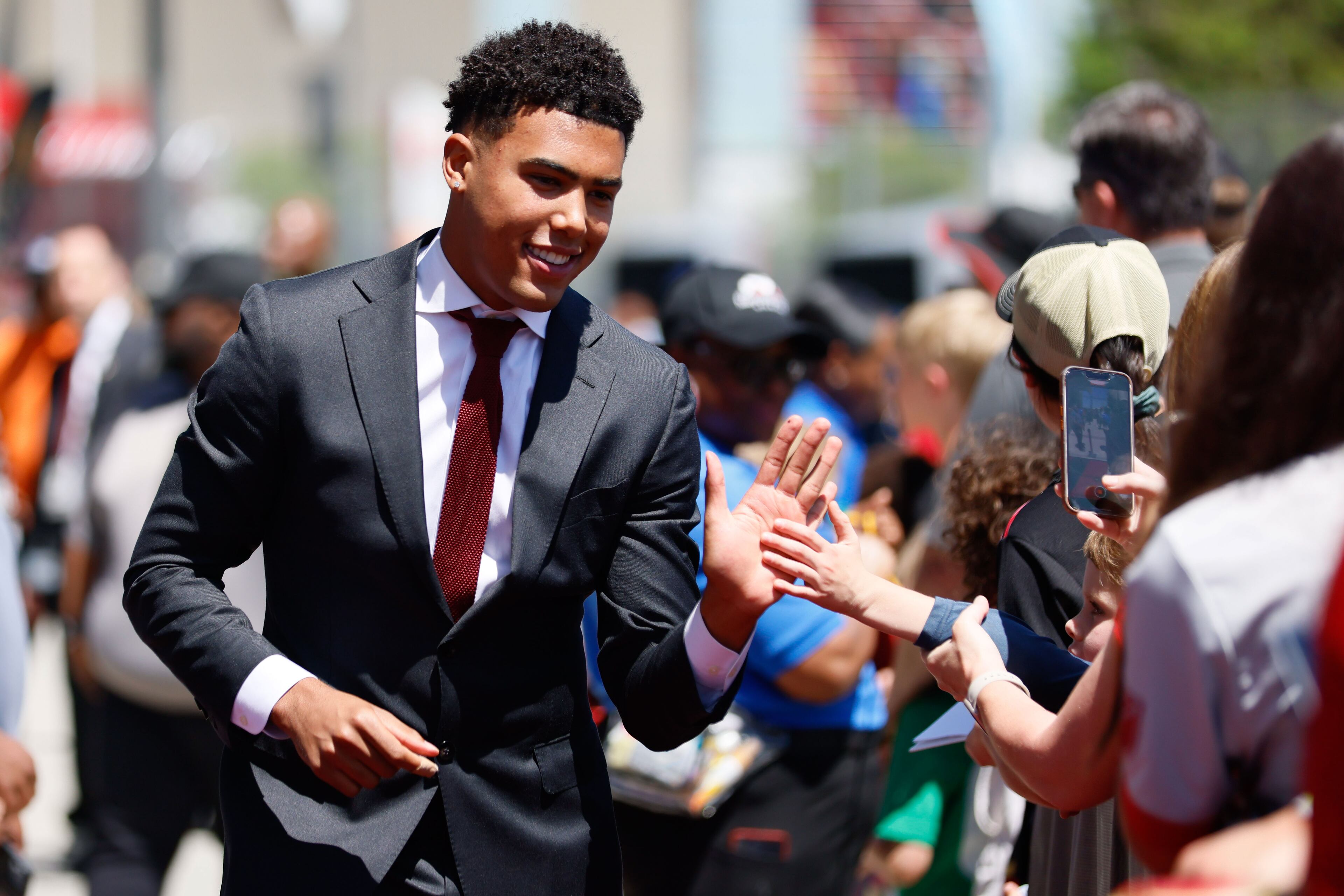 Atlanta United defender Caleb Wiley (26) high-fives fans.
Miguel Martinez / miguel.martinezjimenez@ajc.com