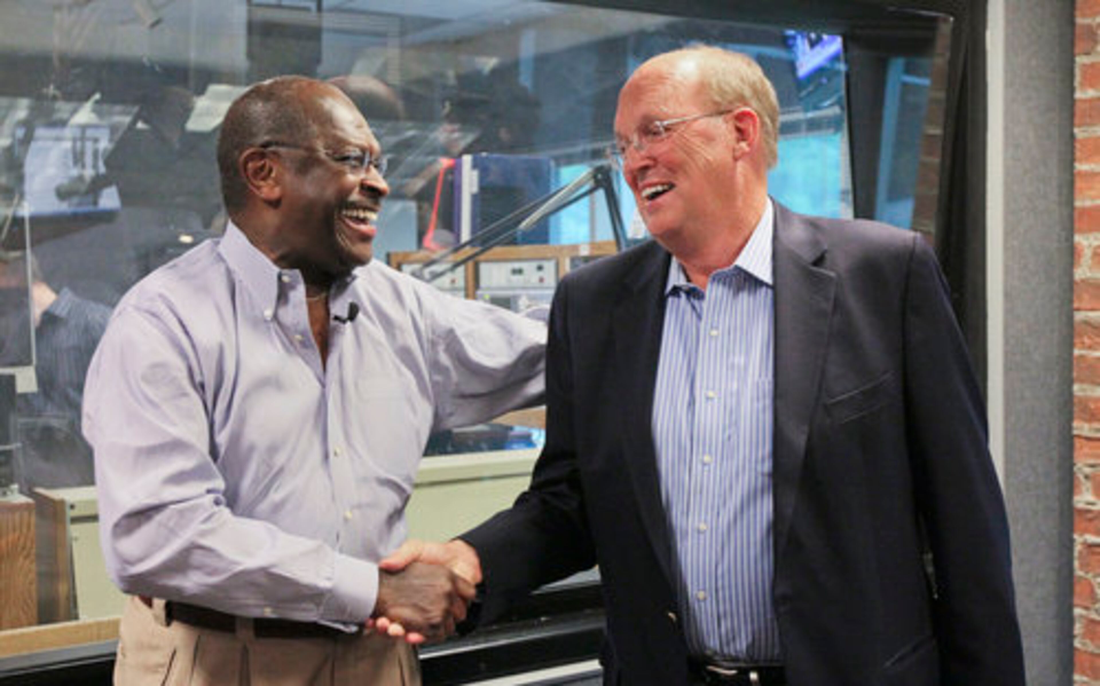 Herman Cain congratulates Neal Boortz (right) on his retirement announcement after the pair went on the air together at WSB Radio. Cain will take over Boortz's post the day after the inauguration of the next U.S. president.