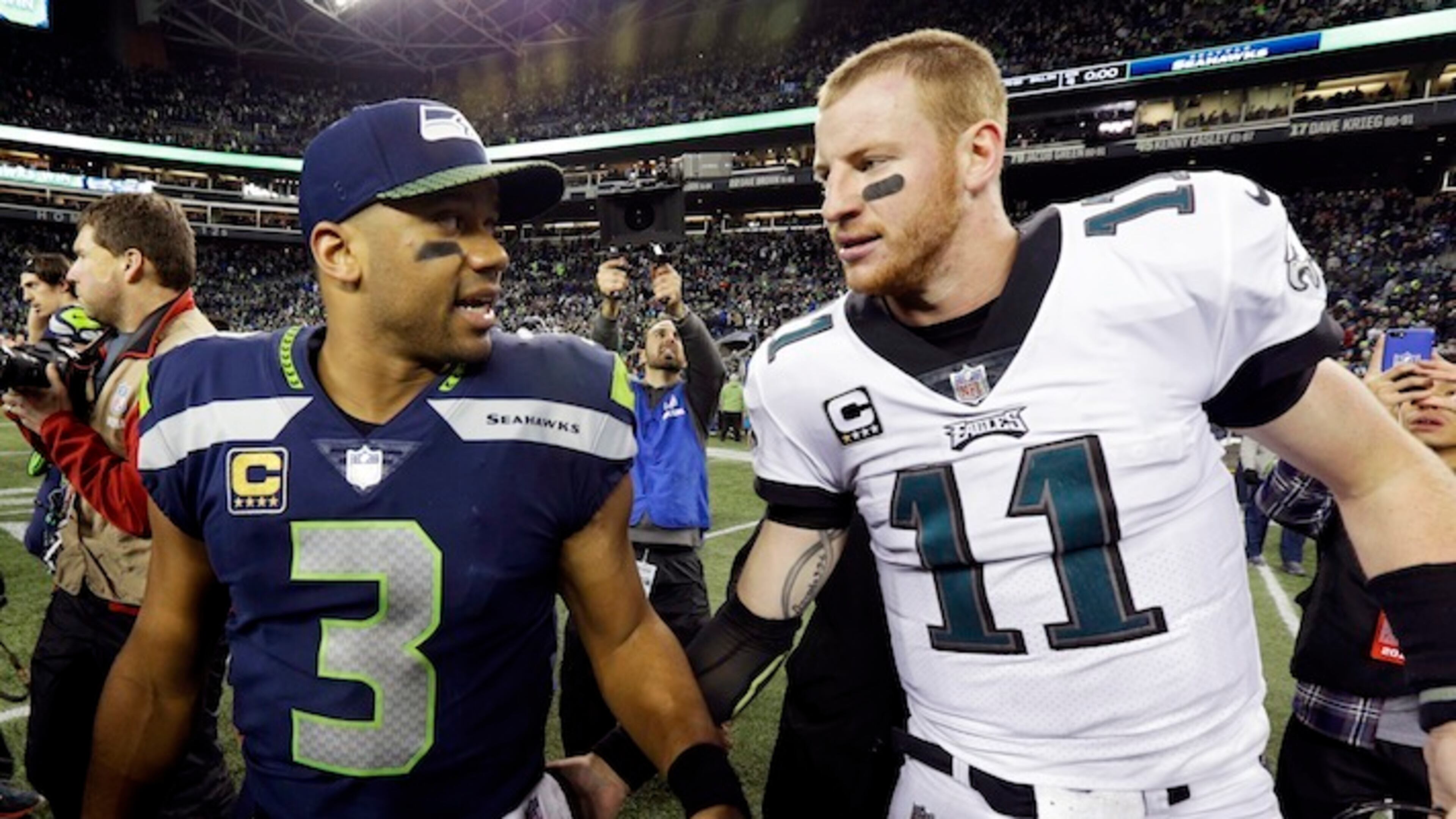 Seattle Seahawks quarterback Russell Wilson (3) talks with Philadelphia Eagles quarterback Carson Wentz after an NFL football game, Sunday, Dec. 3, 2017, in Seattle. The Seahawks won 24-10. (AP Photo/Ted S. Warren)