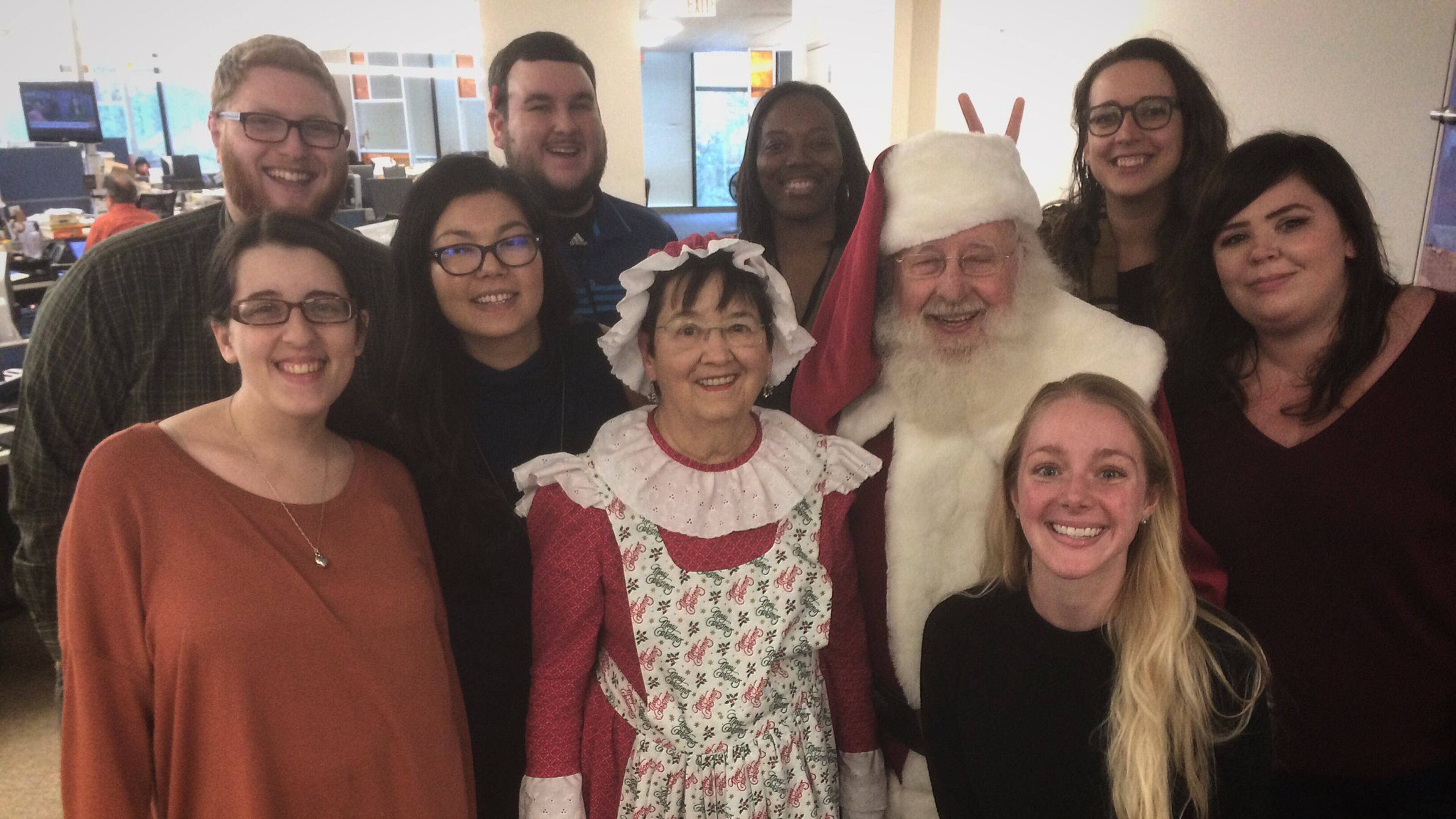 Santa and Mrs. Claus visit the AJC’s Hyperlocal team. Back row, L to R, Cobb Reporter Ben Brasch, N. Fulton Reporter Mitch Northam, Hyperlocal Coach Janel Davis, Intown Atlanta Reporter Becca Godwin, Middle row, SEO Content Producer Courtney Martinez, Hyperlocal Senior Editor Melissa Hall, Mrs. Santa Claus, Santa Claus, Gwinnett Reporter Amanda Coyne. Kneeling, Social Media Producer Kelly Audette. Not pictured is DeKalb Reporter Joshua Sharpe.
