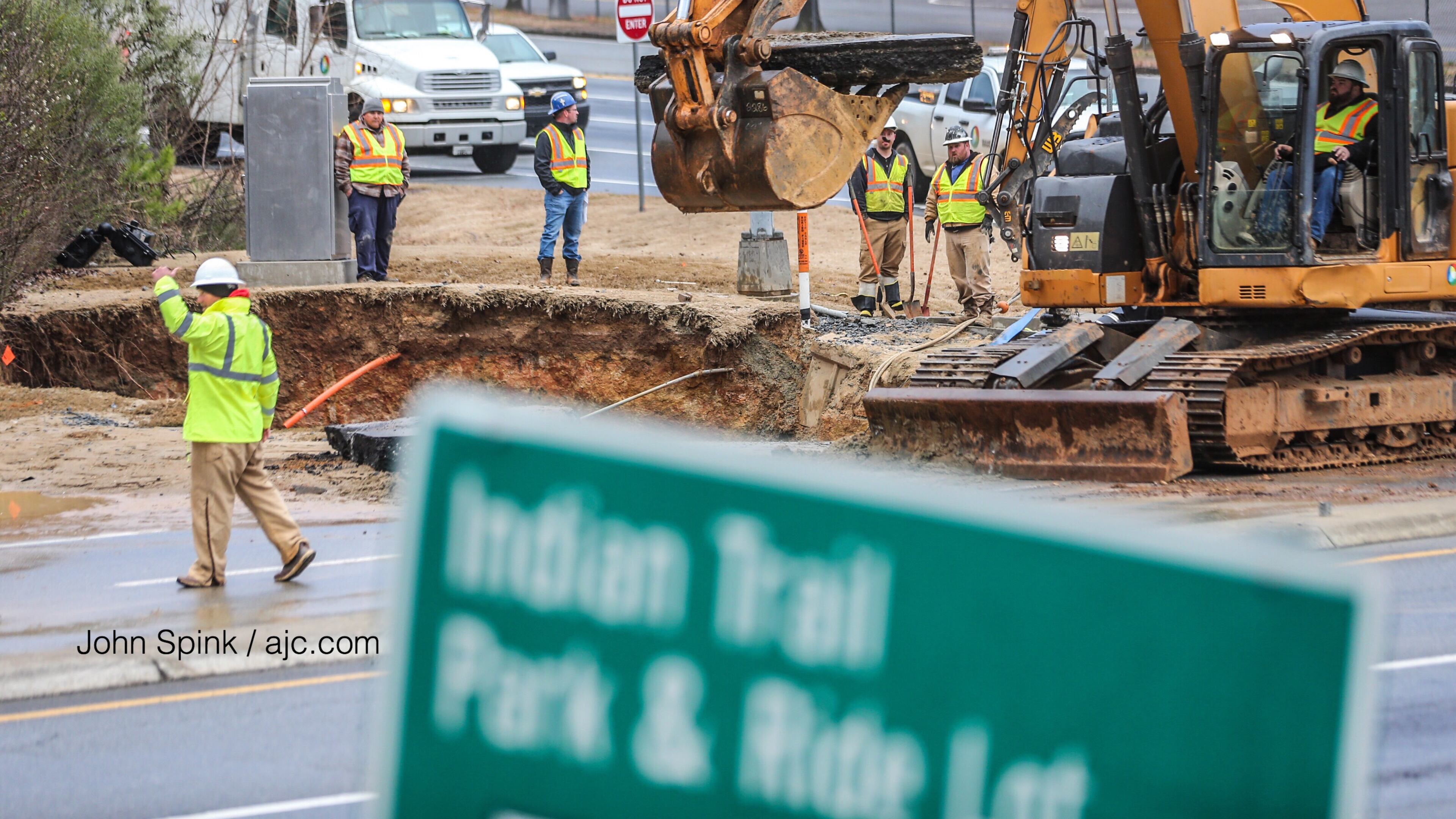 Crews worked to repair a water main break that caused a large section of Indian Trail Road to collapse in Norcross early Tuesday morning.