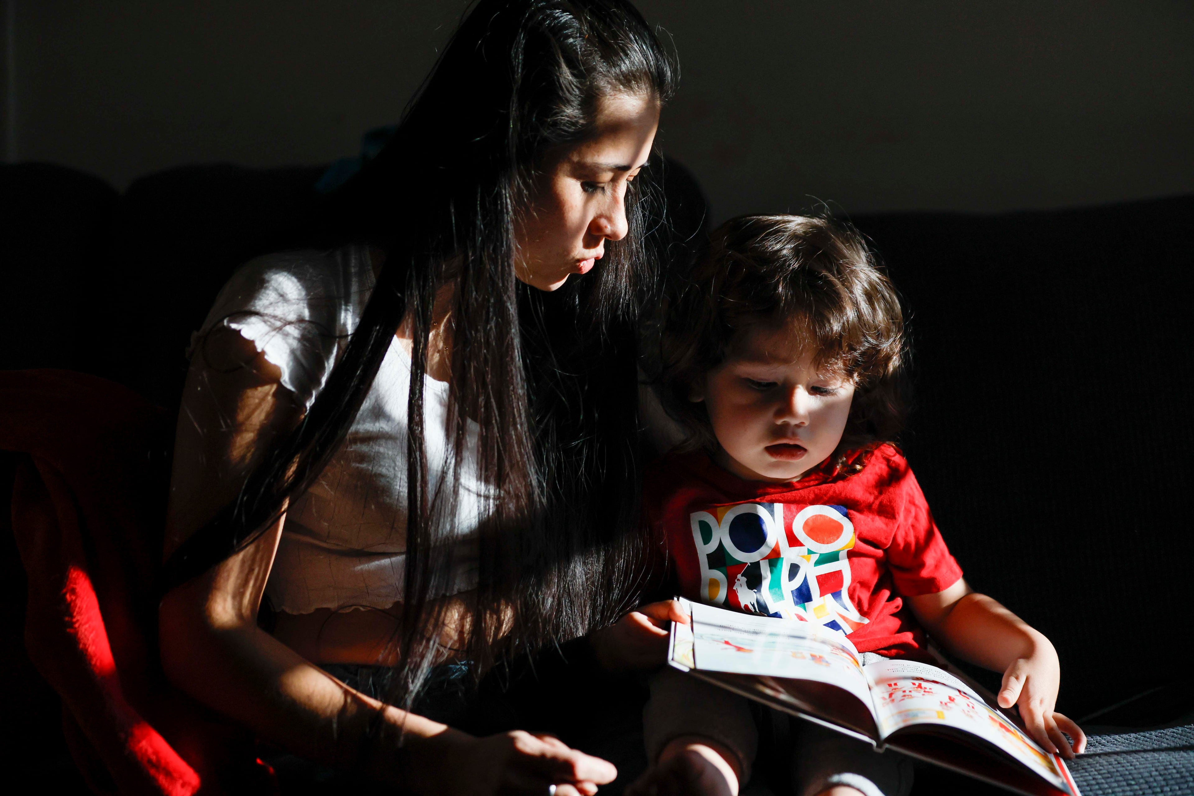 Ceudy Gutierrez reads a book to her 2-year-old son, Matias Gutierrez, at their home in Buford, GA, on Tuesday, Nov. 18, 2025. Ceudy Gutierrez is struggling to make ends meet for herself and her three young kids following her husband’s ICE arrest earlier this fall.
(Miguel Martinez/ AJC)