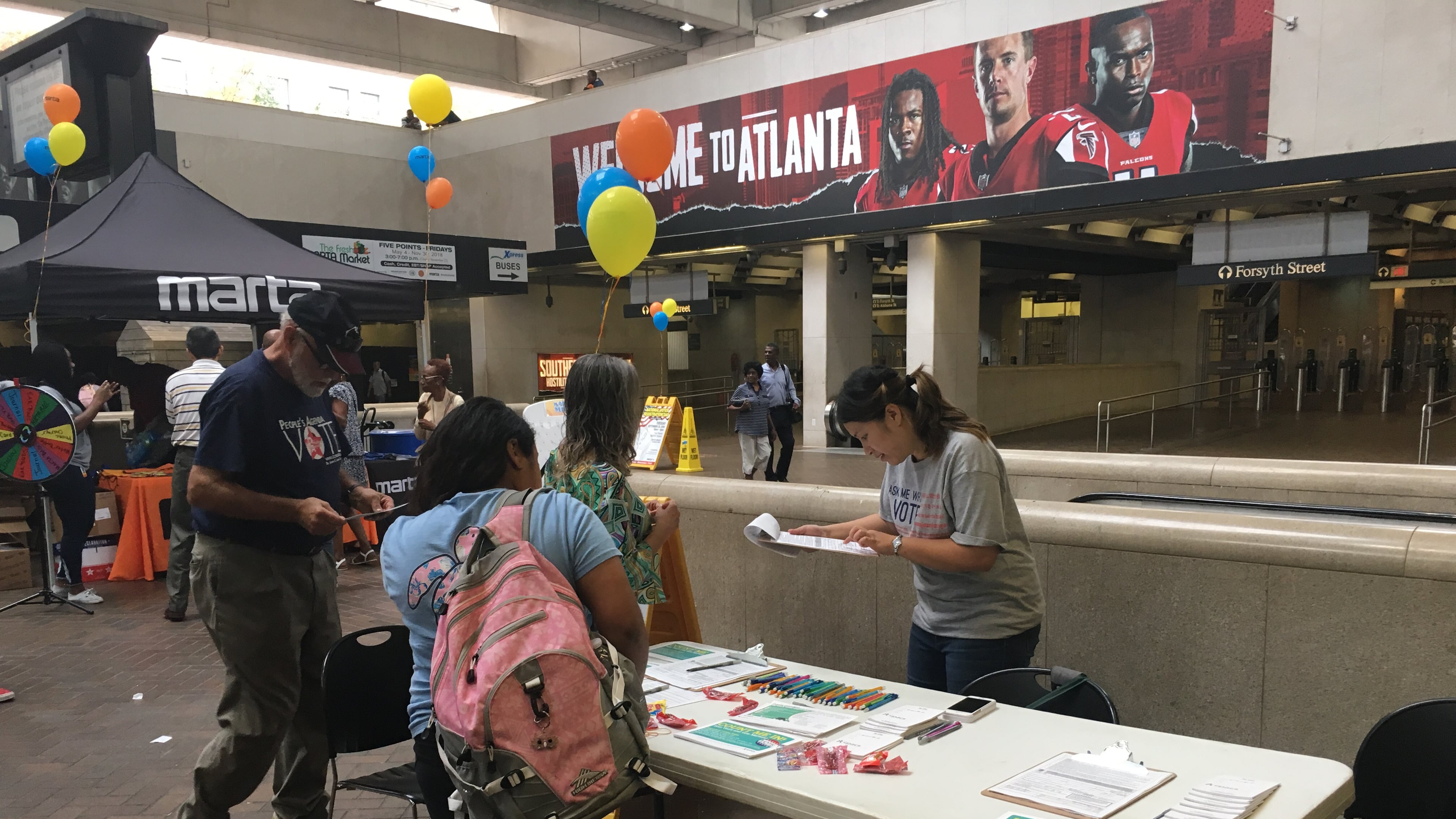 Victoria Huynh (right), vice president of Center for Pan Asian Community Services, helps answer voter registration questions on Sept. 25, 2018.