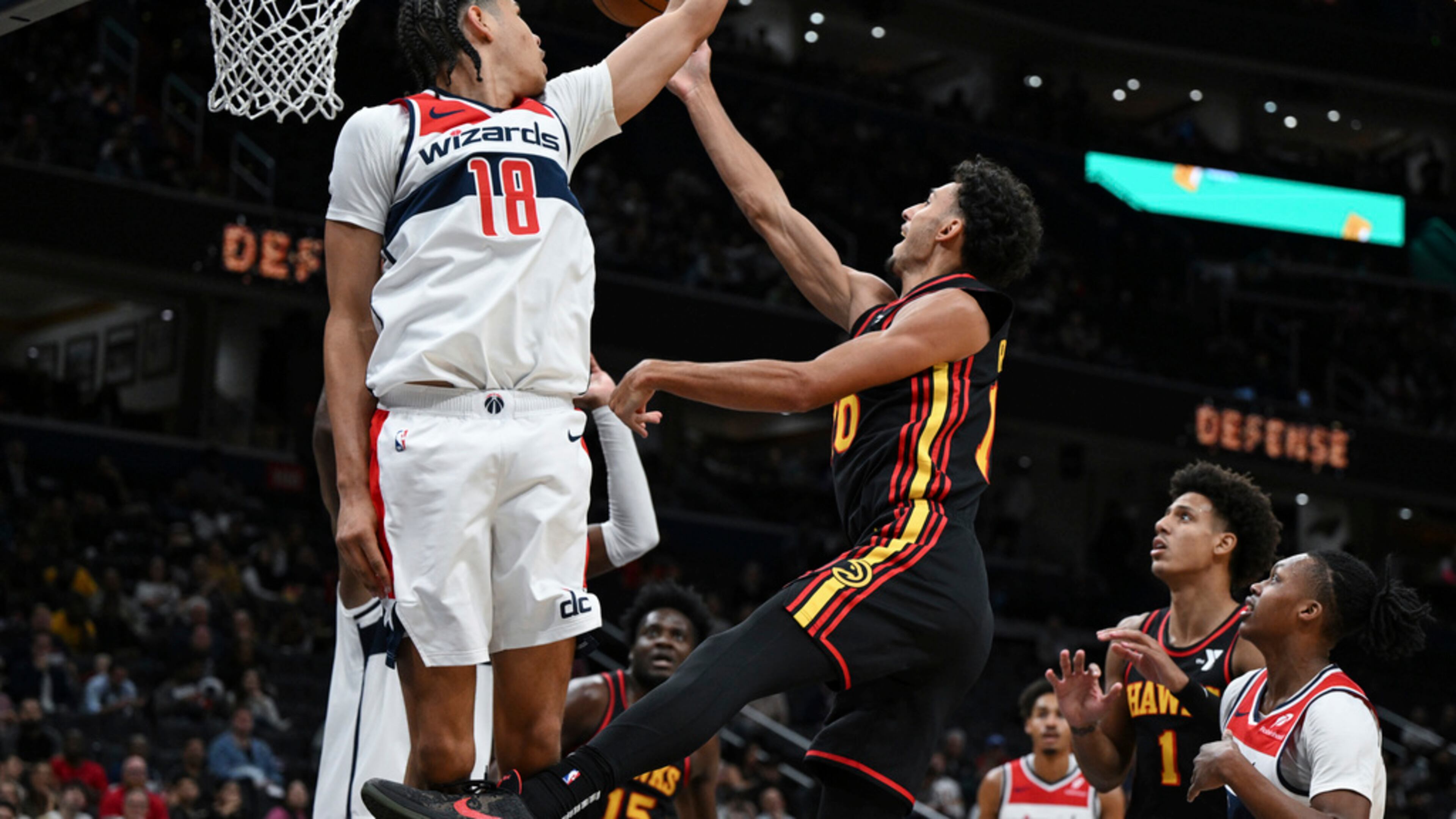Atlanta Hawks forward Zaccharie Risacher (10) goes to the basket and attempts a lay-up against Washington Wizards forward Kyshawn George (18) during the second half of an NBA basketball game, Wednesday, Oct. 30, 2024, in Washington. (Terrance Williams/AP)