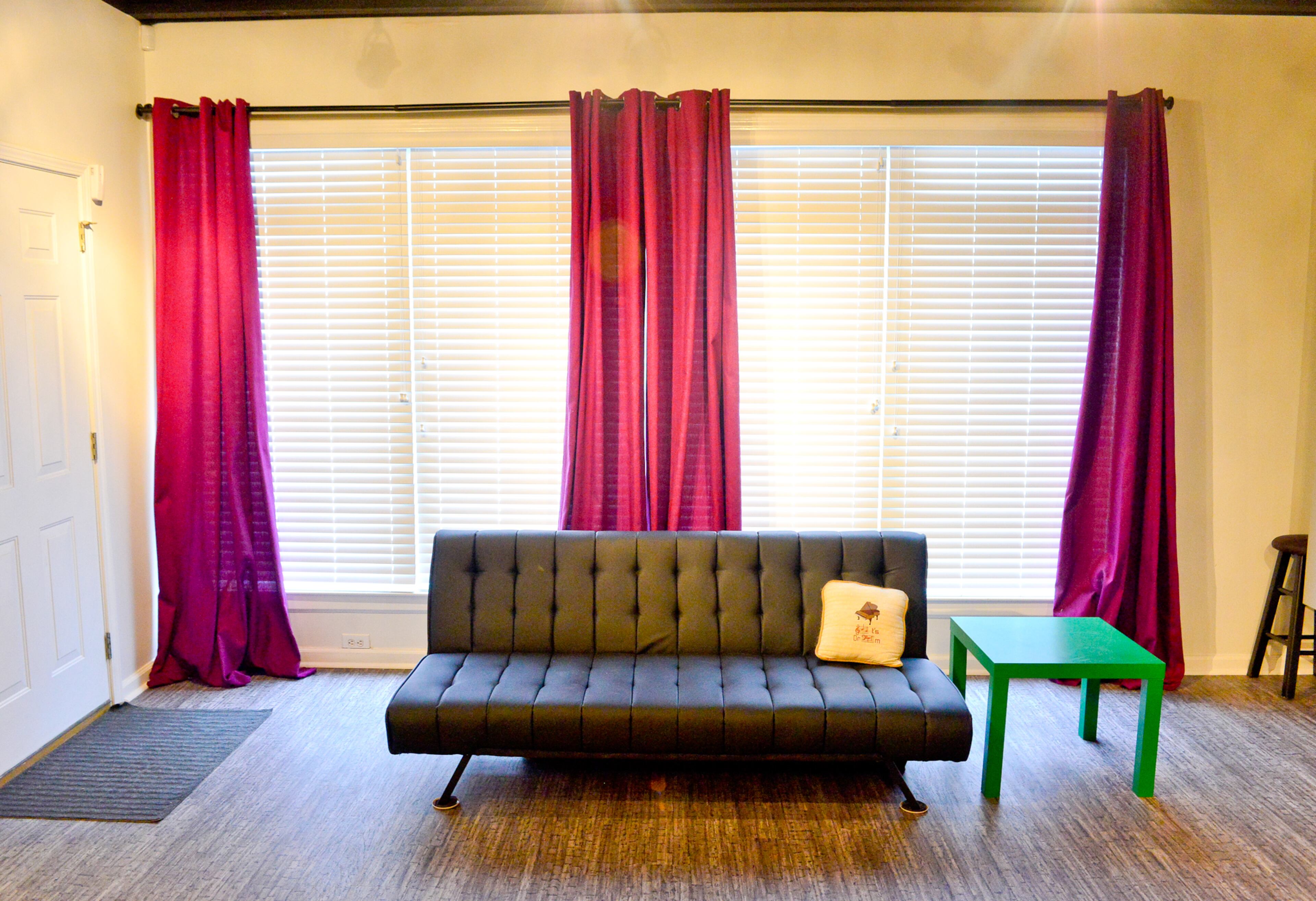 The couch by Abbyson Living adds a comfortable place for the couple to lounge after a practice session. It also folds down, doubling as a bed when the homeowners need additional sleeping space for guests. The flooring is a luxury vinyl tile, called Exotic Wood, by Tandus Centiva.