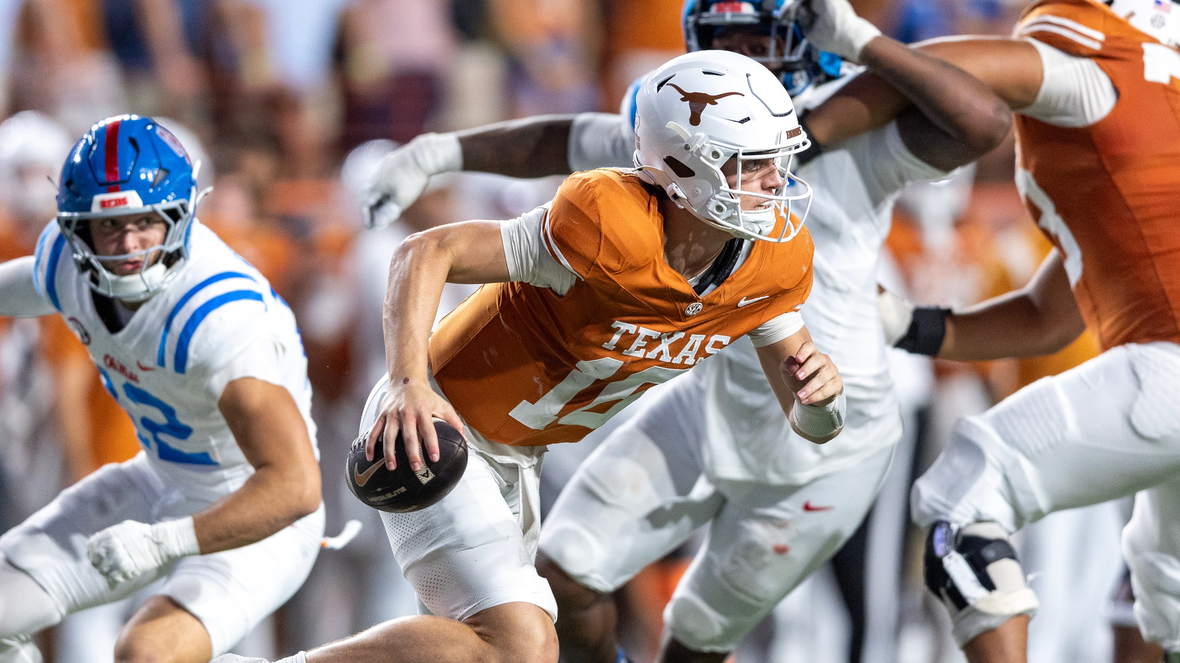 Texas quarterback Arch Manning (16) escapes pressure by Mississippi linebacker Luke Ferrelli, left, during the second half of an NCAA college football game in Austin, Texas, Saturday, Oct. 24, 2026. (AP Photo/Stephen Spillman)