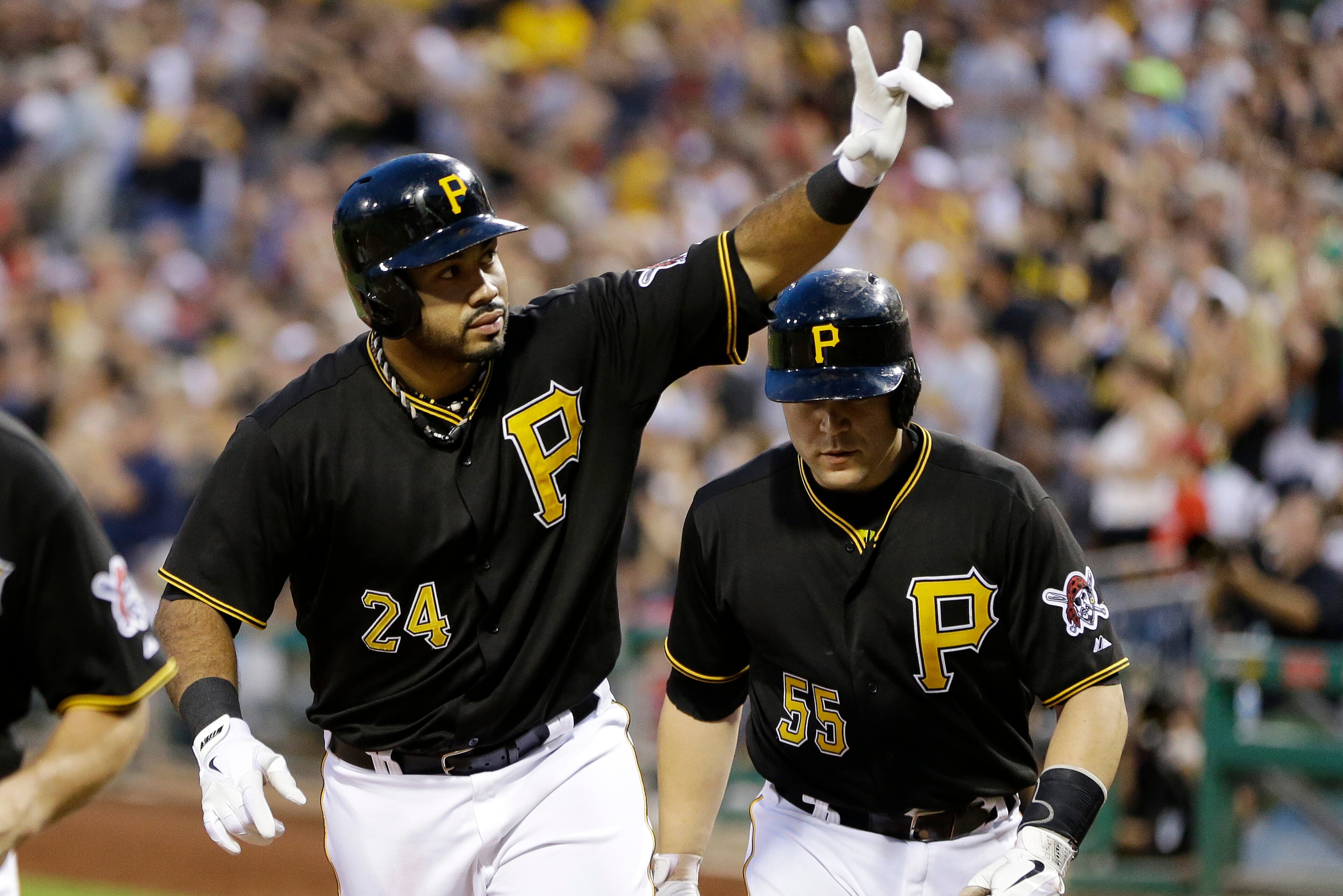 Pittsburgh Pirates' Pedro Alvarez (24) celebrates as he returns to the dugout with teammate Russell Martin (55) who also scored on his three-run home run off Philadelphia Phillies starting pitcher John Lannan during the fifth inning of a baseball game in Pittsburgh, Wednesday, July 3, 2013. (AP Photo/Gene J. Puskar)