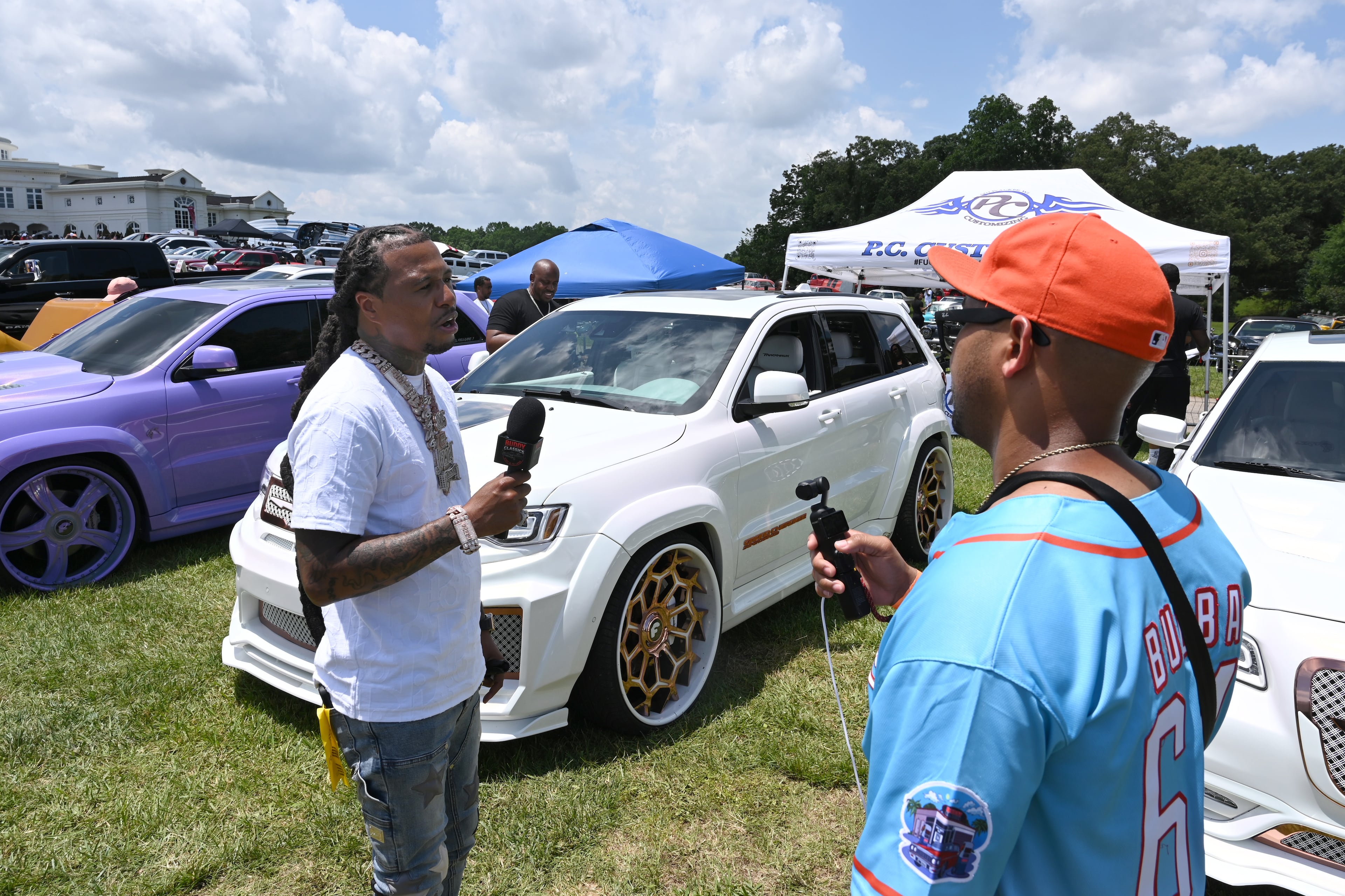 Corey Jones, also known as CJ On 32s, is being interviewed during the 4th Annual Rick Ross Car and Bike Show, Saturday, June 7, 2025, in Fayetteville. The 4th Annual Rick Ross Car and Bike Show will include a vendor market with more than 30 vendors, food trucks, fleets of classic/custom automobiles, luxury vehicles, boats, RVs and trailers on the front of the mansion. Stage performances include Plies, Ross' new signee Nino Breeze and Ross himself. (Hyosub Shin / AJC)