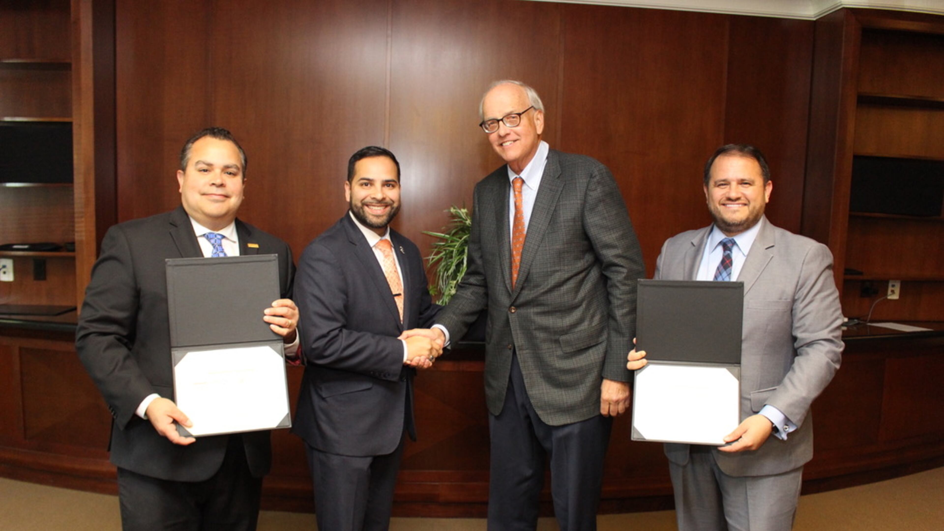 From left, Santiago Marquez (president and CEO) and Antonio Molina (chairman-elect) from the Georgia Hispanic Chamber of Commerce pose for a picture with the Gwinnett Chamber's Tom Andersen (board chair) and Nick Masino (president and CEO). COURTESY GWINNETT CHAMBER