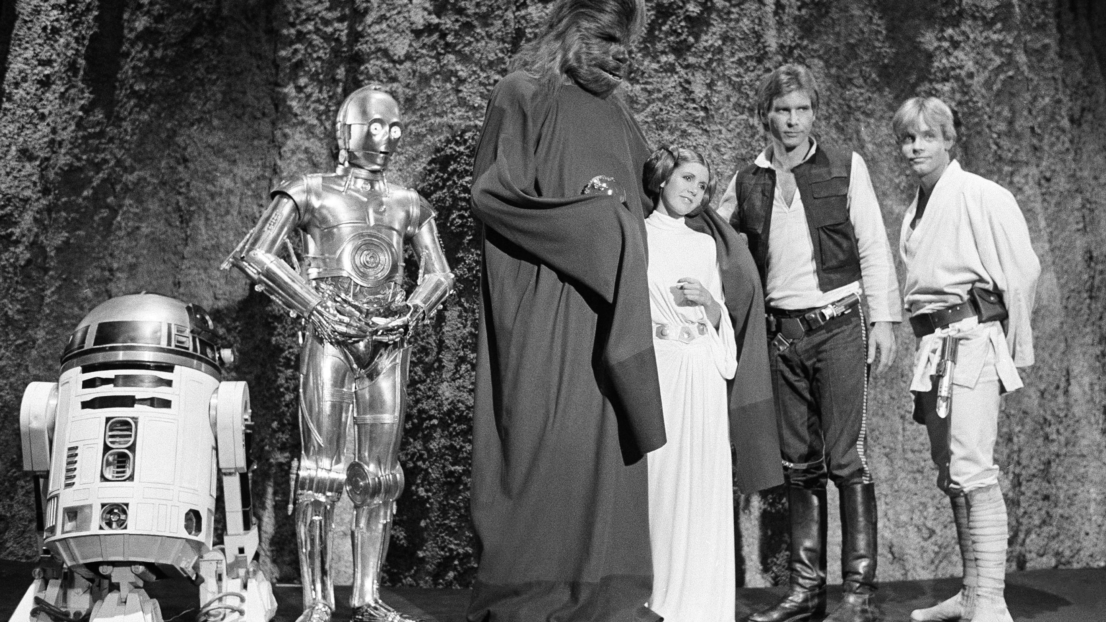FILE - Kenny Baker, from left, Anthony Daniels, Peter Mayhew, Carrie Fisher, Harrison Ford and Mark Hamill are seen during the filming of the CBS-TV special, "The Star Wars Holiday," in Los Angeles, Nov. 13, 1978. (AP Photo/George Brich, File)