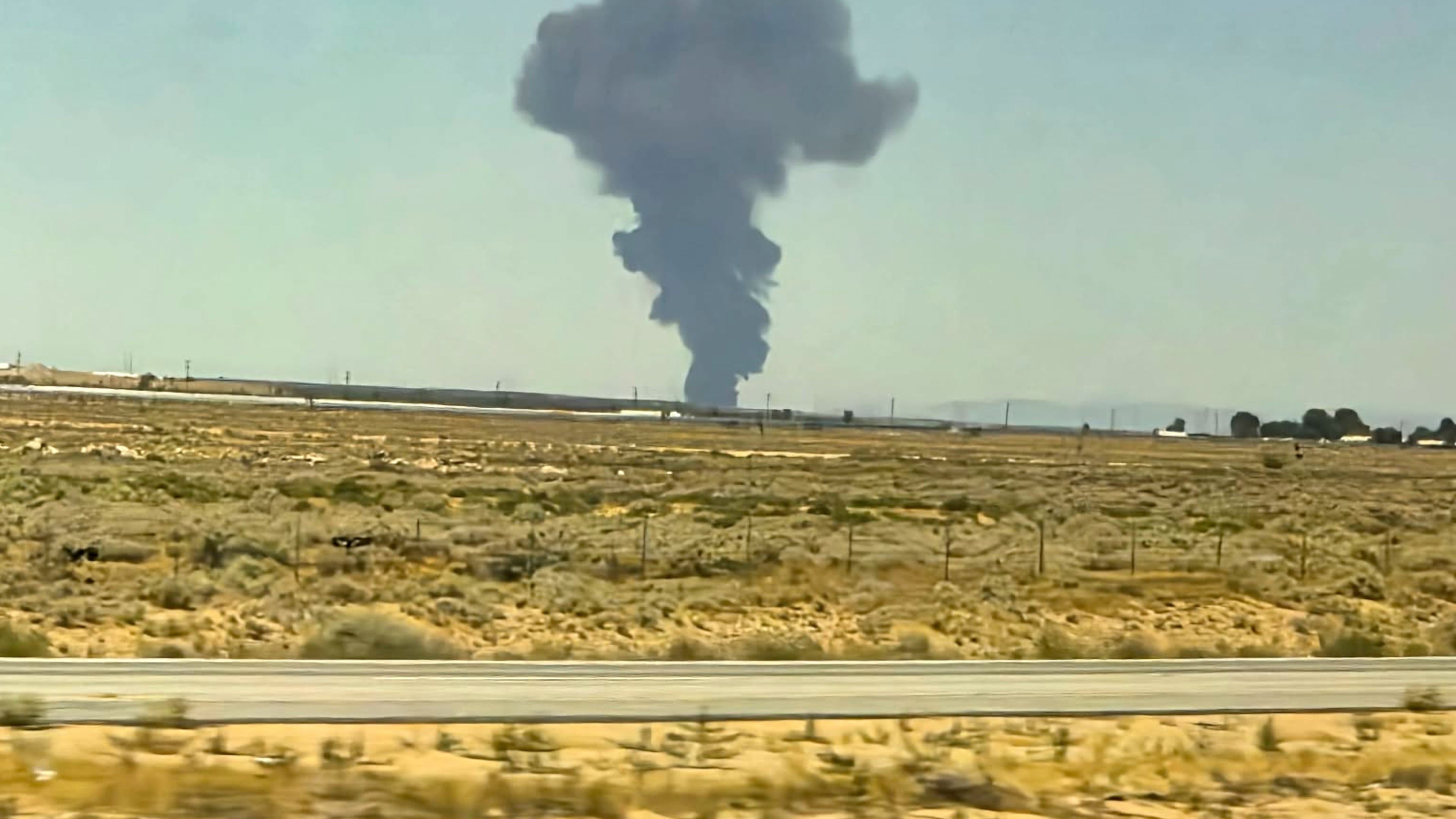 Smoke plumes rise from a B-52 bomber that crashed shortly after takeoff at a U.S. Air Force base in Southern California, Monday, June 15, 2026. (Debbie Reyes Katz via AP Photo)