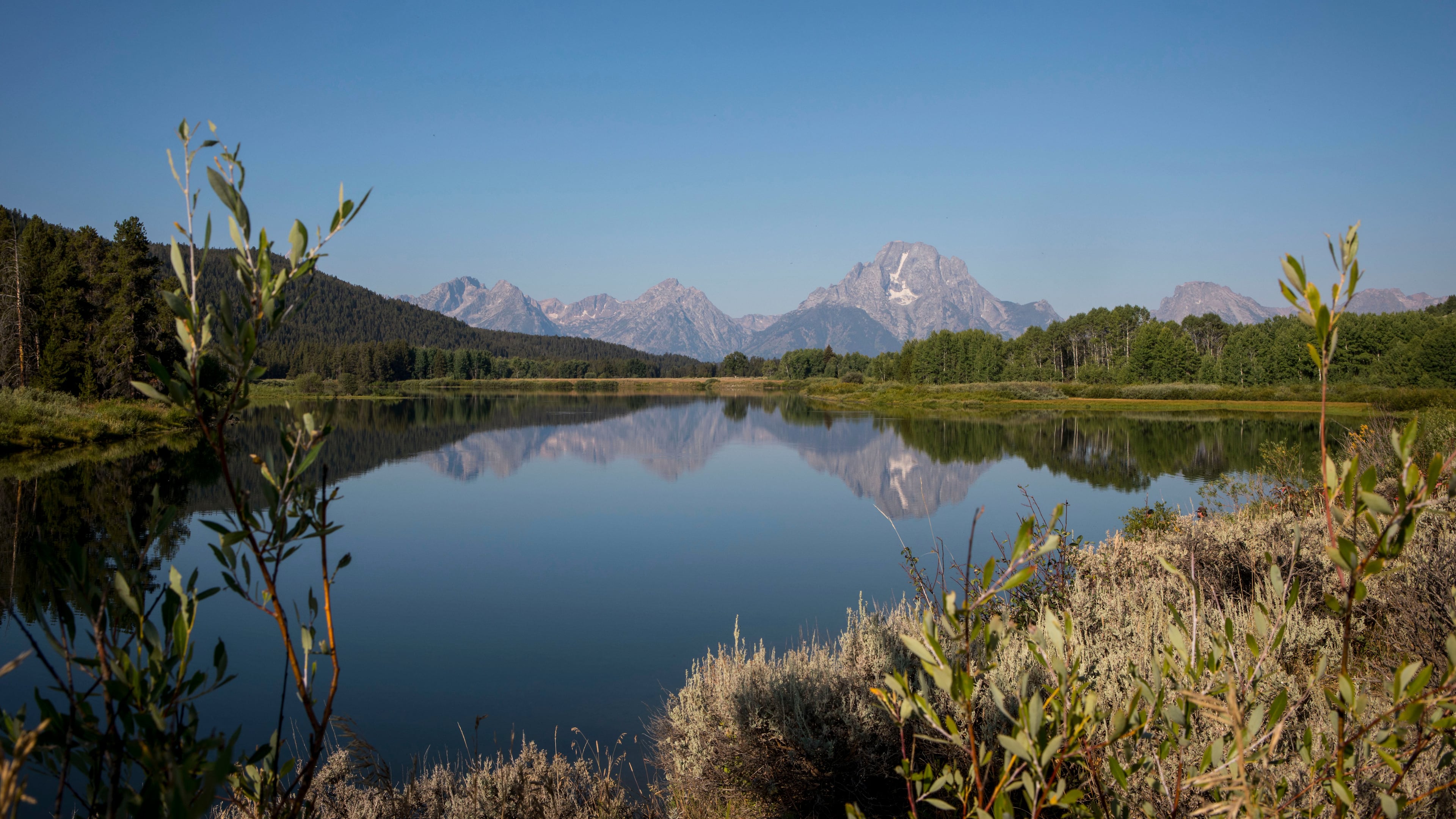 FILE - The Teton mountains reflect on Oxbow Bend in Grand Teton National Park in Moran, Wyo., Aug. 22, 2025. (AP Photo/Amber Baesler, File)
