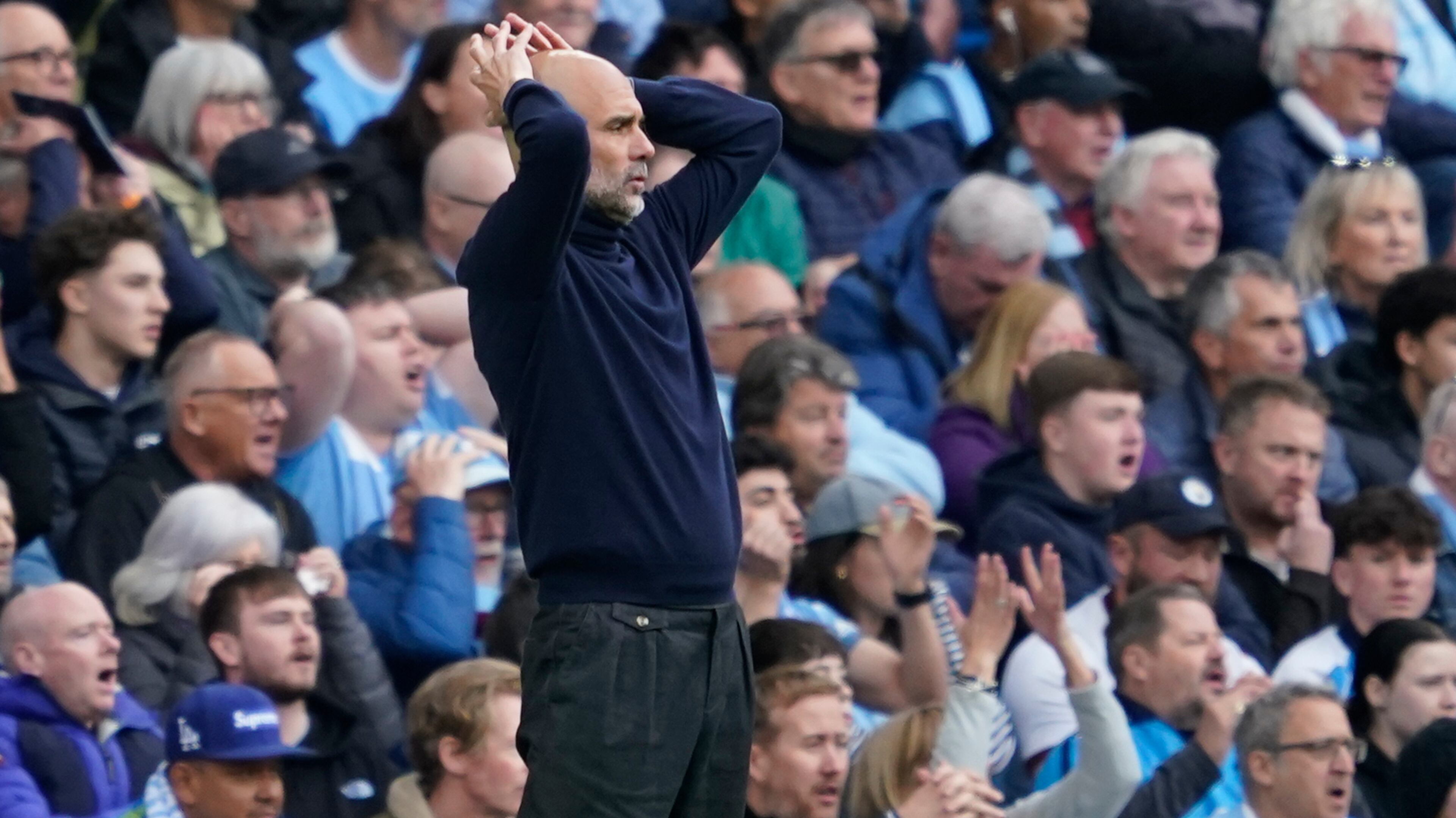 Manchester City's head coach Pep Guardiola gestures during the English Premier League soccer match between Manchester City and and Arsenal, in Manchester, England, Sunday, April 19, 2026. (AP Photo/Dave Thompson)