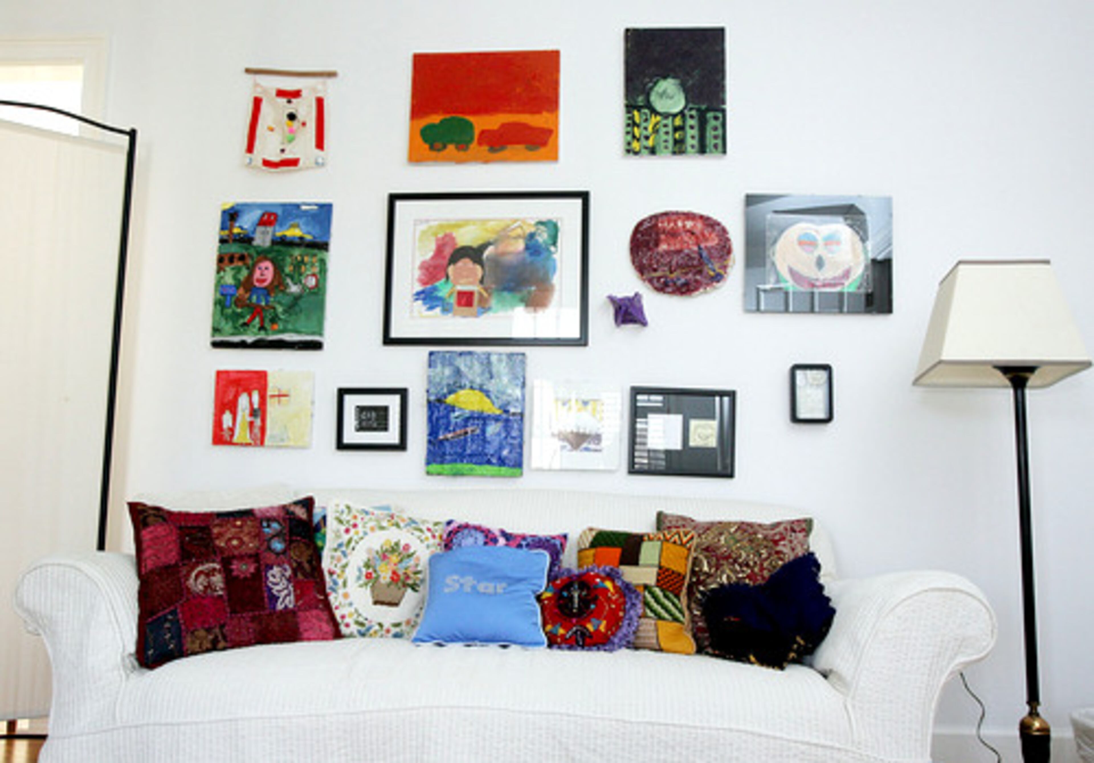 This wall features a salon-hung collection of framed art by Lyla, from finger painting to collage.