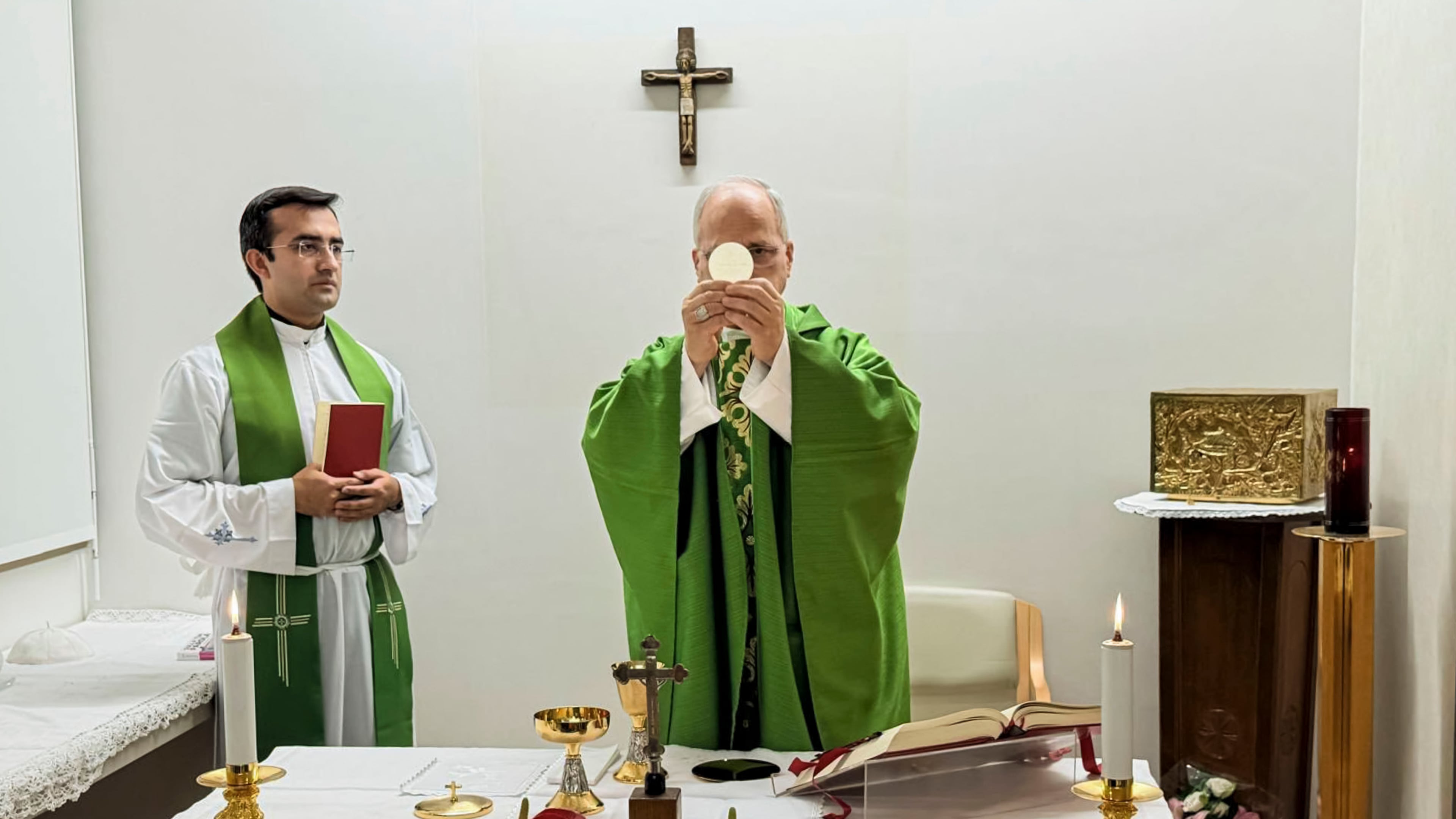 This picture, released by Vatican Media on Friday, Oct. 16, 2026, shows Pope Leo XIV, flanked by his personal secretary, Monsignor Edgard Iván Rimaycuna Inga, left, celebrating Mass at the Agostino Gemelli Polyclinic in Rome, where he is recovering after having cancer removed from his right lung. (Vatican Media via AP)