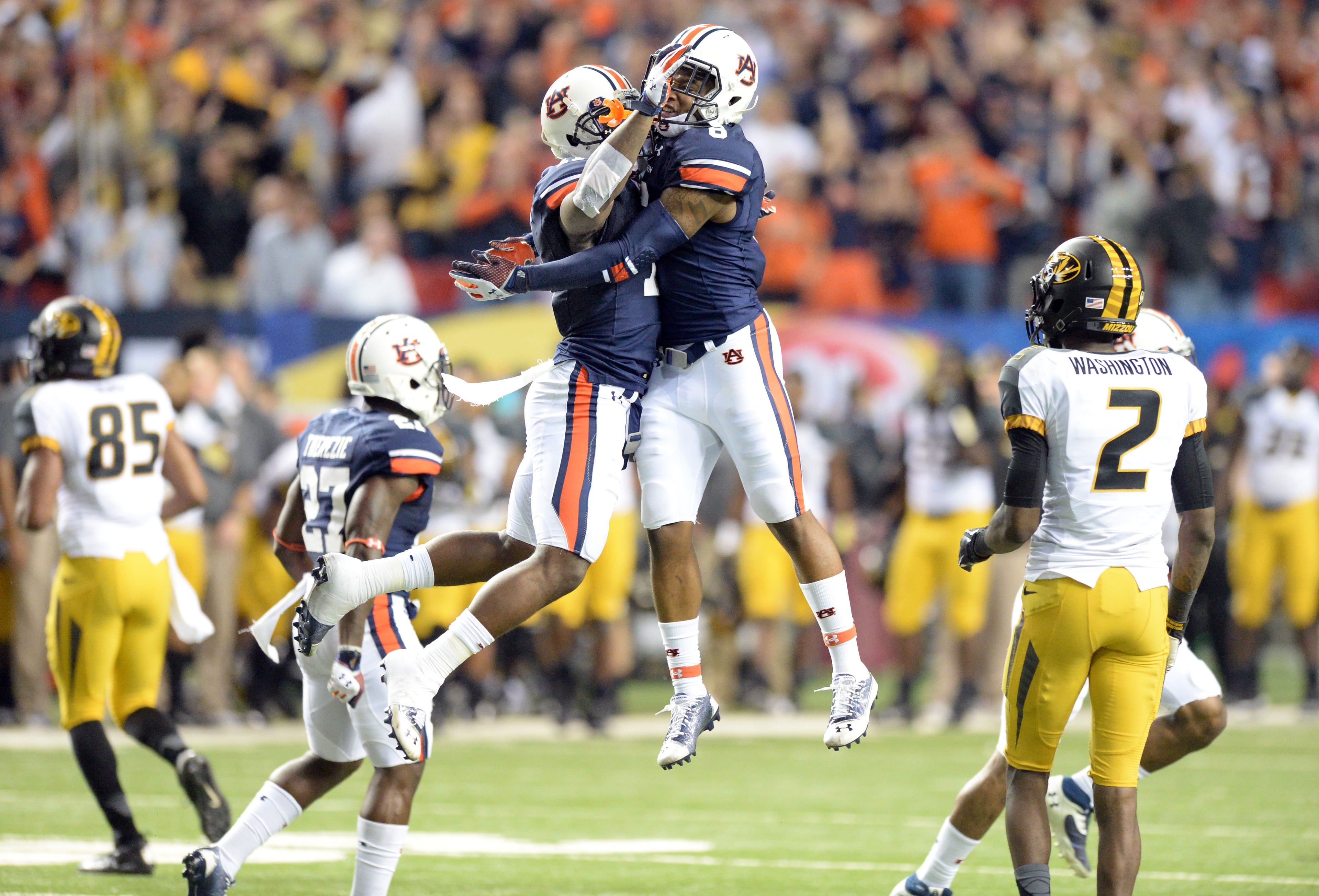 Auburn Tigers cornerback Chris Davis (left) and Auburn Tigers defensive back Jonathon Mincy (right) celebrate during the second half of the SEC Championship game at Georgia Dome on Saturday, December 7, 2013. Auburn Tigers won 59-42. HYOSUB SHIN / HSHIN@AJC.COM
