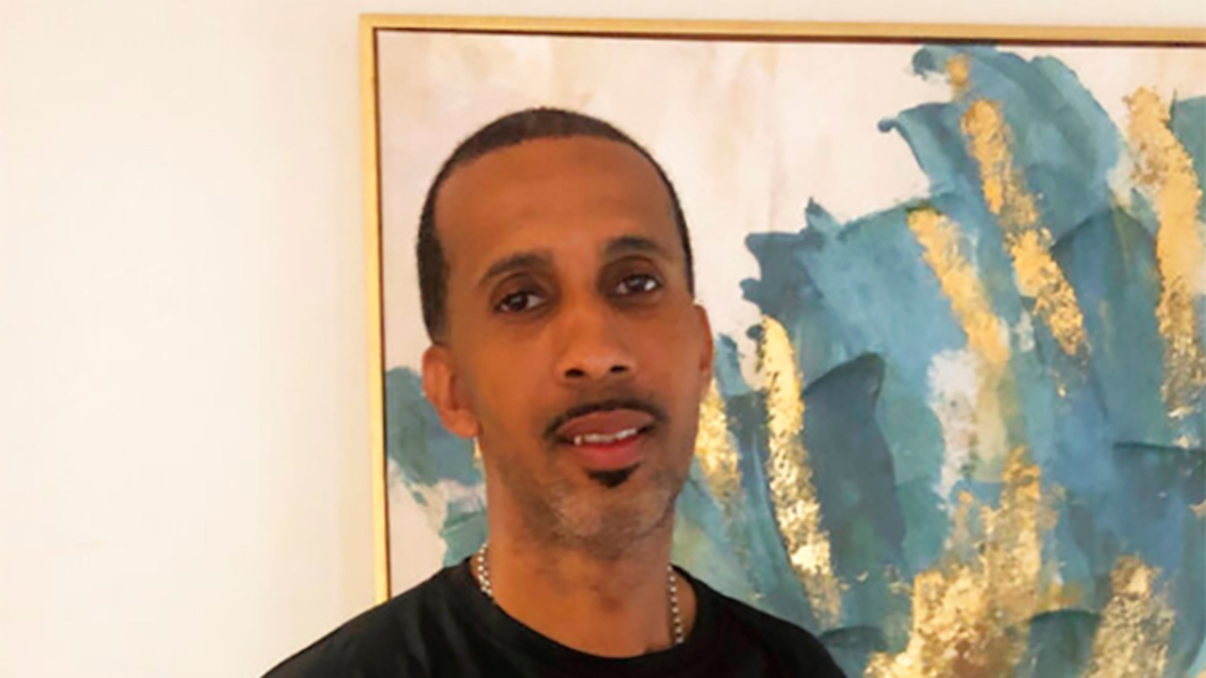 Rapper McKinley "Mac" Phipps stands in his New Orleans home, Wednesday, the day after he was released on parole after serving more than 20 years for a 2001 manslaughter conviction in connection with a nightclub shooting in Slidell, Louisiana. The parole for Phipps, who has long maintained he was wrongfully convicted for the shooting, was granted Tuesday.