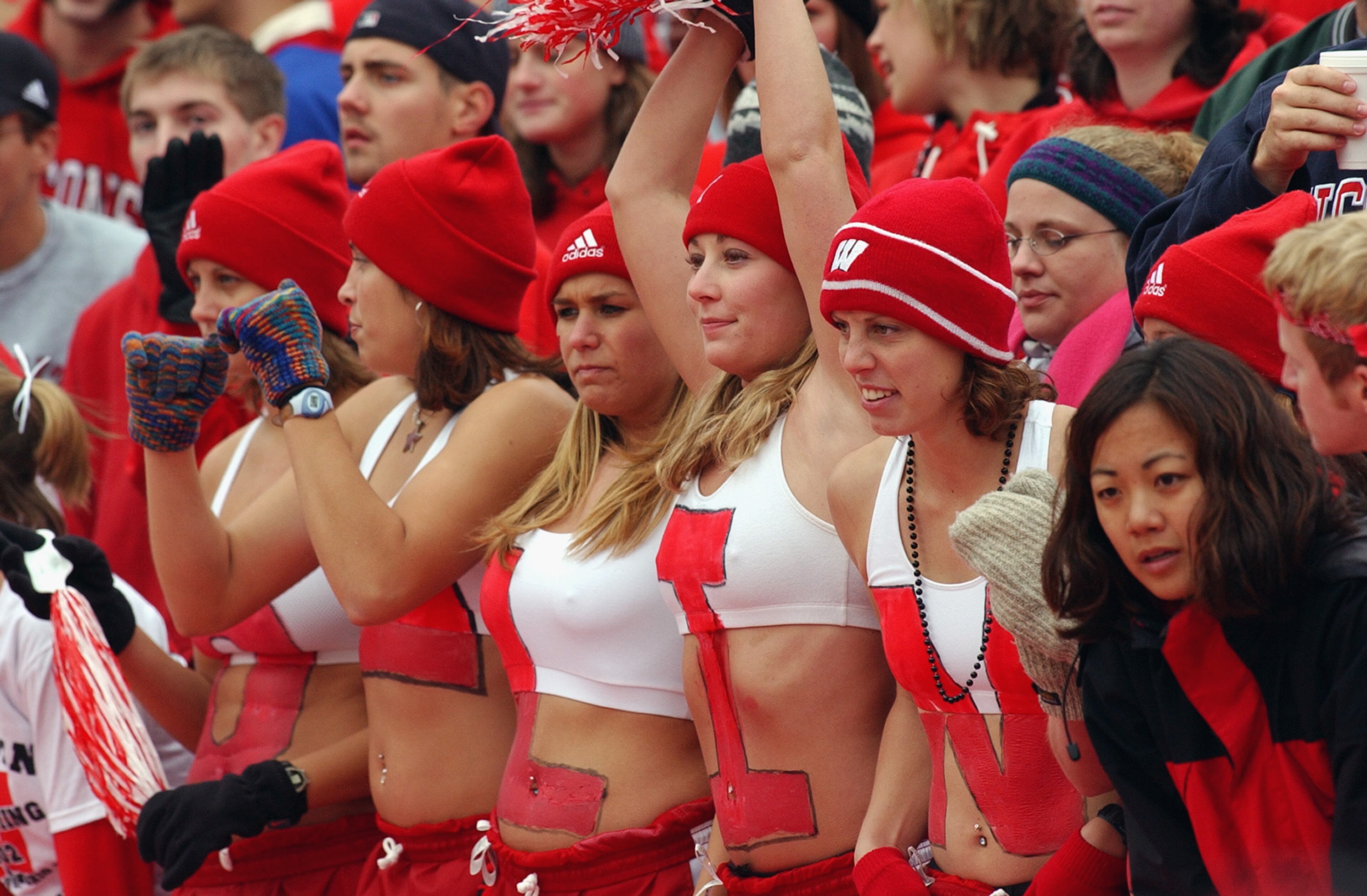 Fans of the Wisconsin Badgers cheer on the offensive line during the Big Ten Conference football game against the Ohio State Buckeyes at Camp Randall Stadium on October 19, 2002, in Madison, Wis.