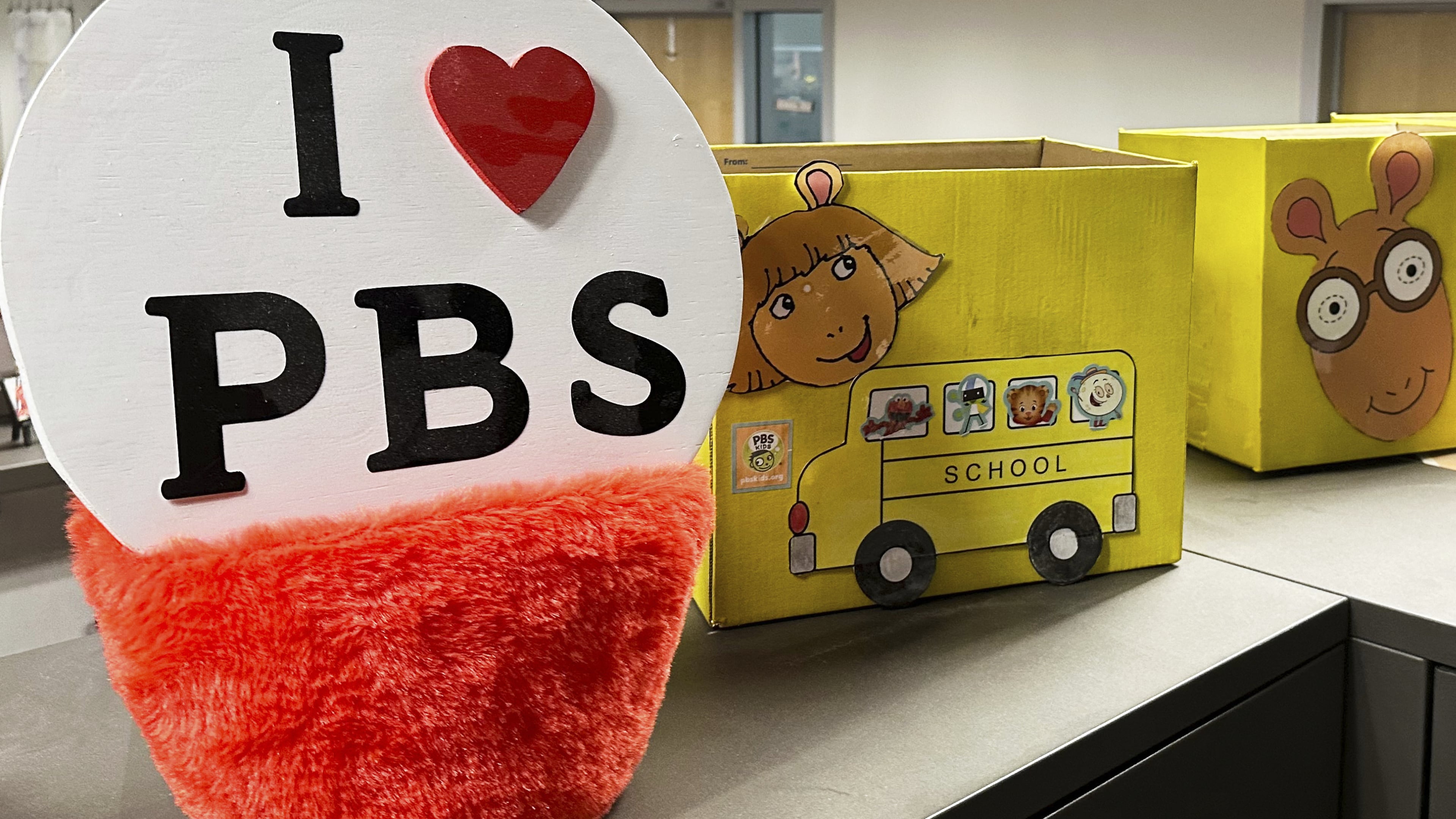 FILE - PBS Kids show characters including the title character from "Arthur" decorate boxes at the Arizona PBS offices in the Walter Cronkite School of Journalism and Mass Communication in Phoenix, May 2, 2025. (AP Photo/Katie Oyan, File)
