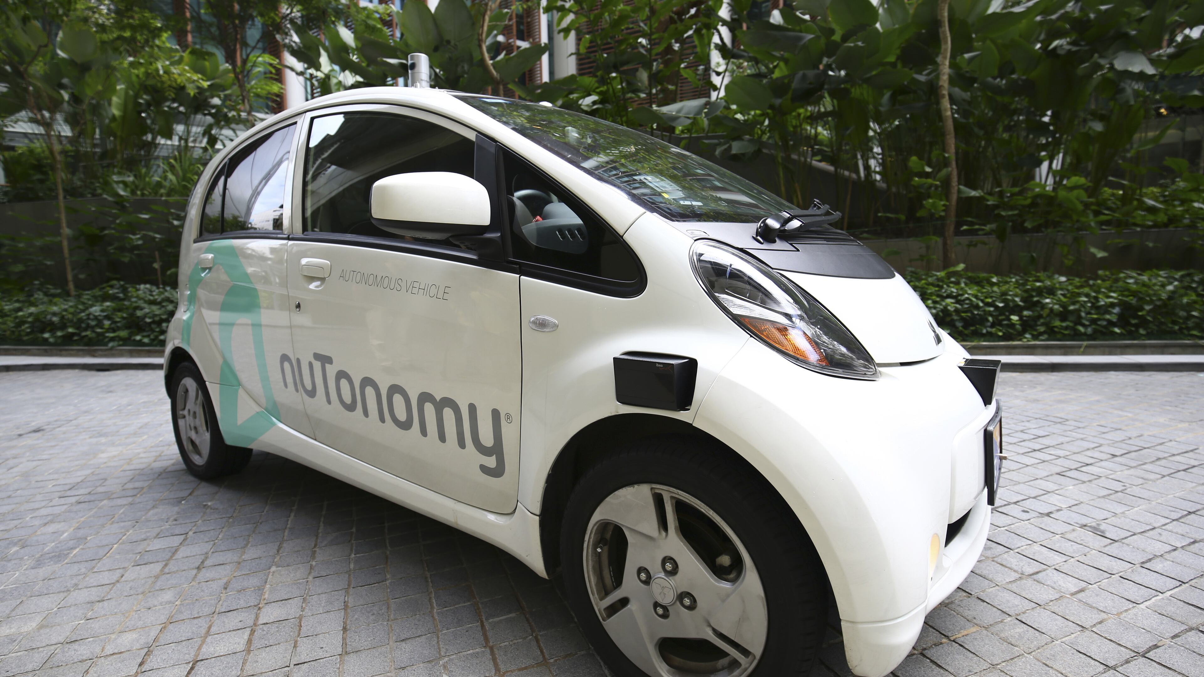 An autonomous vehicle is parked for its test drive in Singapore Wednesday, Aug. 24, 2016. The world’s first self-driving taxis, operated by nuTonomy, an autonomous vehicle software startup, started picking up passengers in Singapore on Thursday, Aug. 25. The service will start small - six cars now, growing to a dozen by the end of the year. The ultimate goal, say nuTonomy officials, is to have a fully self-driving taxi fleet in Singapore by 2018, which will help sharply cut the number of cars on Singapore’s congested roads. (AP Photo/Yong Teck Lim)